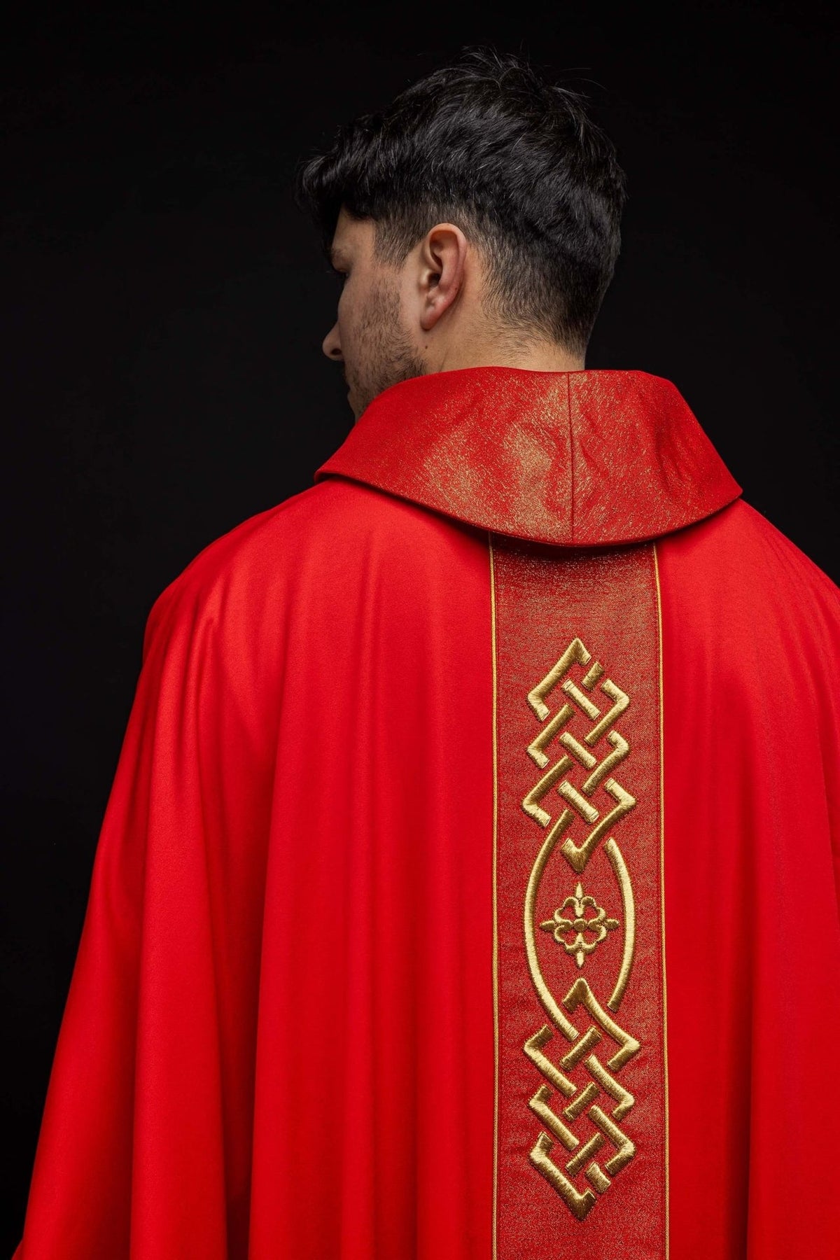 Red chasuble close-up showing the red and gold satin stand-up collar