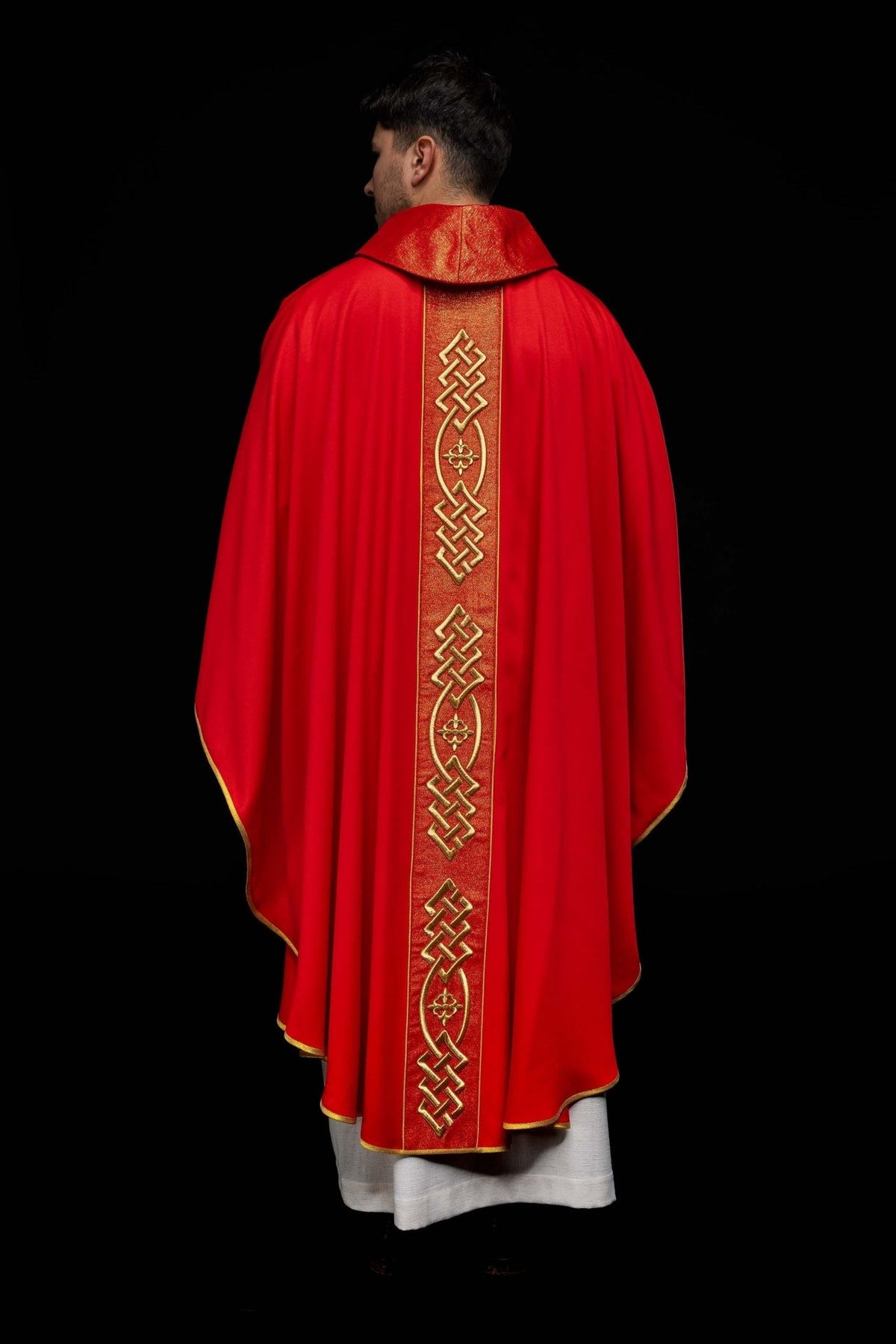 Red chasuble back view with gold embroidered central panel and collar