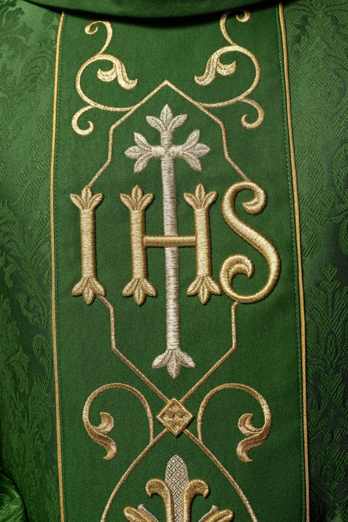 Green chasuble close-up of embroidered gold IHS and silver cross
