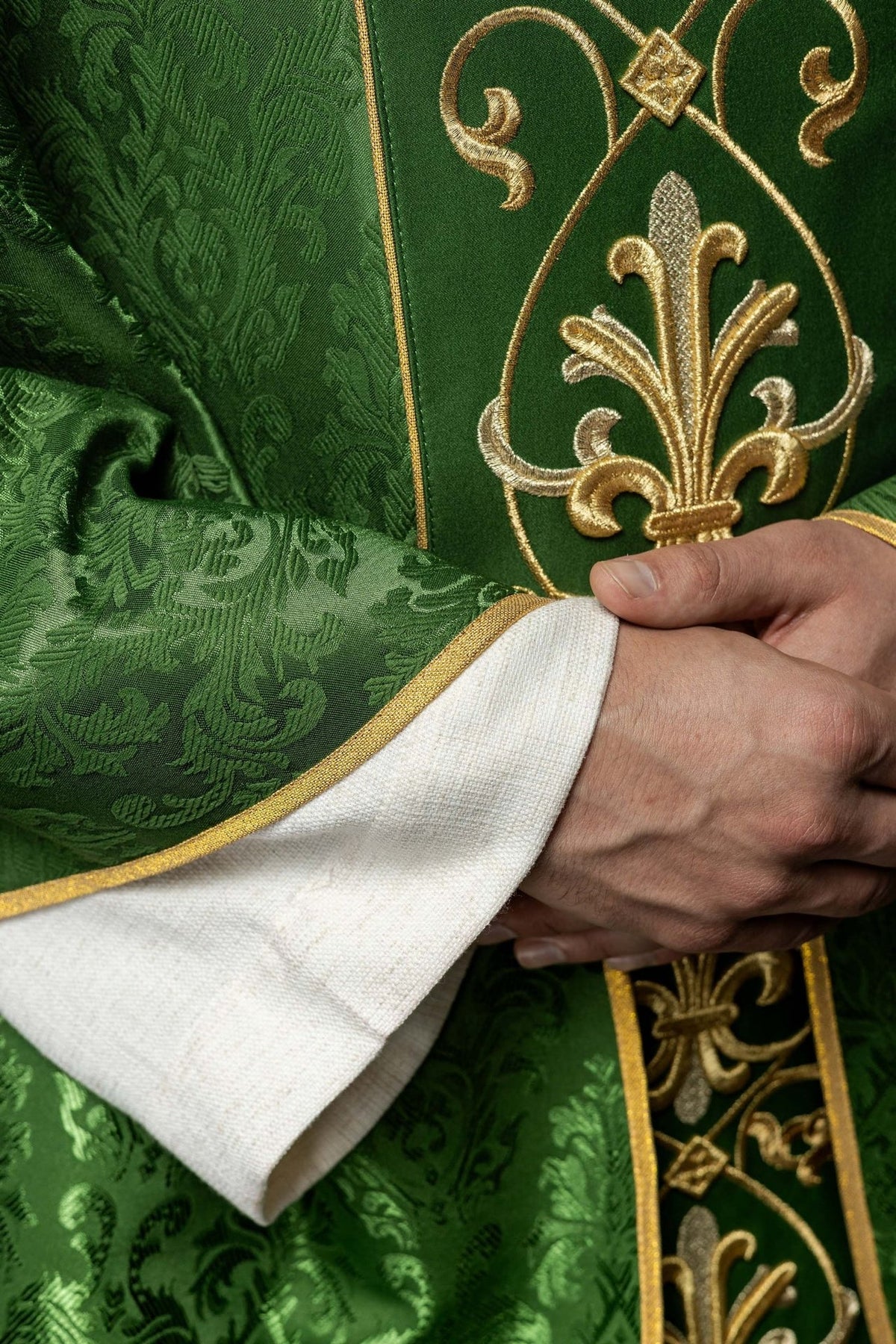 Green chasuble close-up of gold and silver fleur-de-lis embroidery