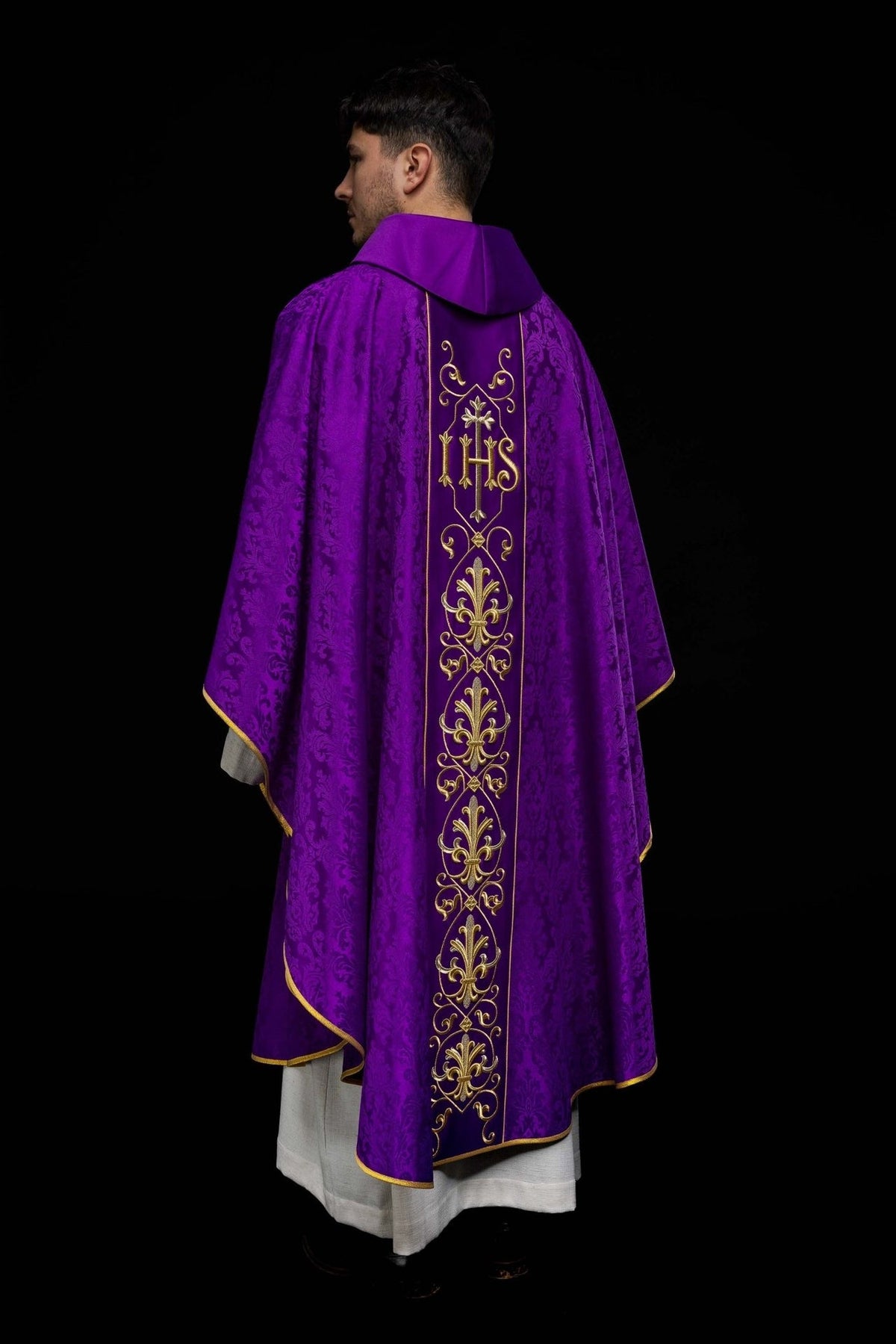 Purple chasuble back view with embroidered IHS panel, floral motifs and gold trim