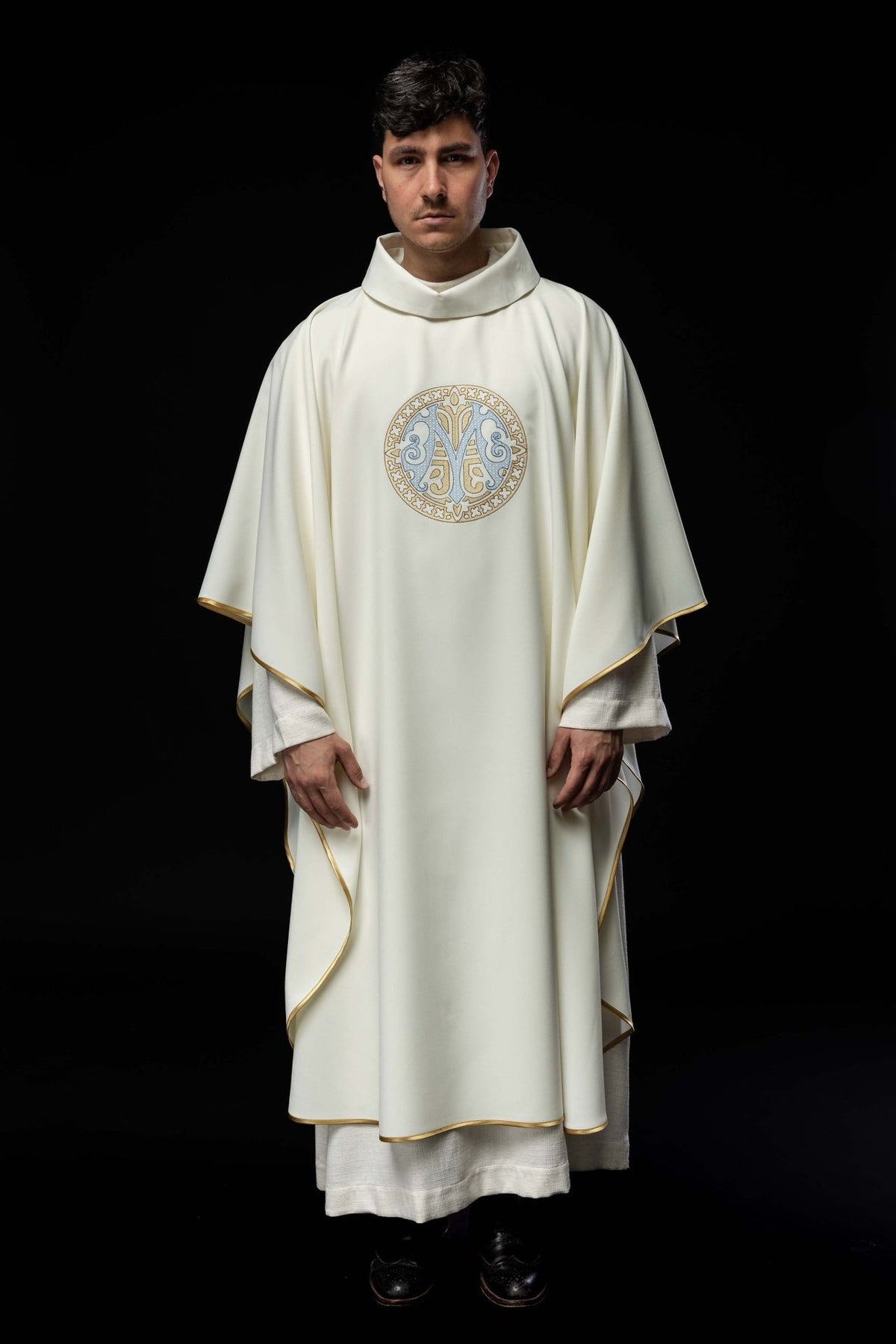 Marian chasuble front view showing ecru fabric, gold trim and embroidered Marian motif