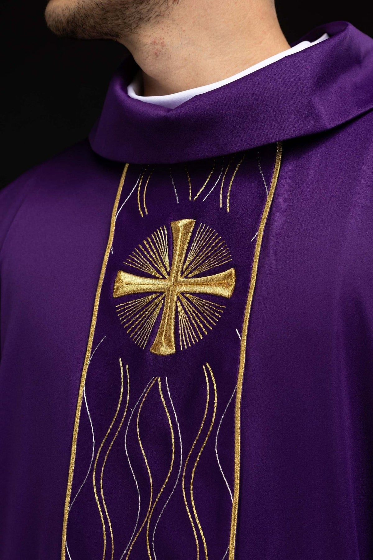 Purple chasuble close-up showing gold cross embroidery and stand-up collar