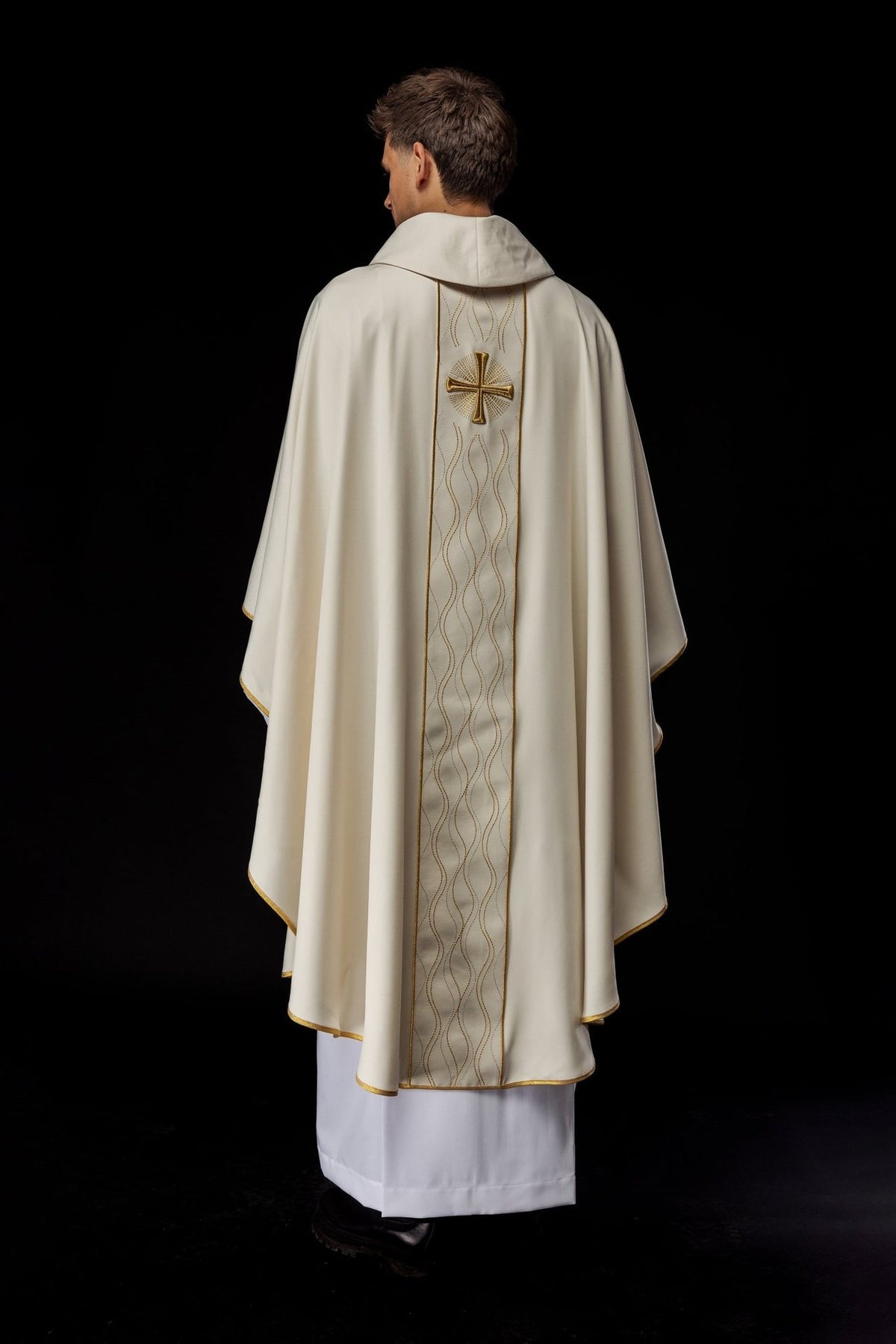 Ecru chasuble worn from the back with embroidered inner stole and gold trim