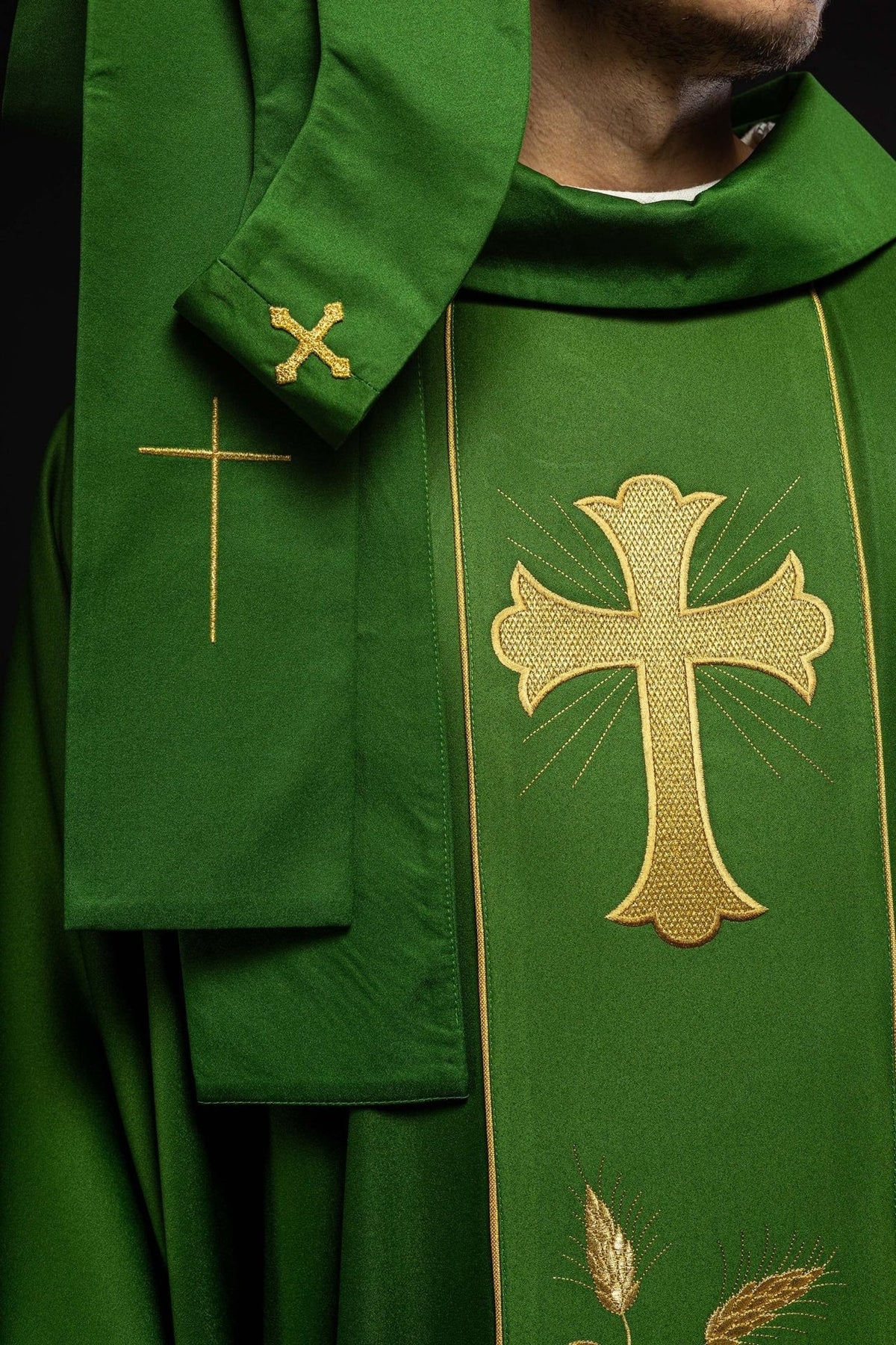 Green chasuble close-up showing stand-up collar, cross embroidery and wheat