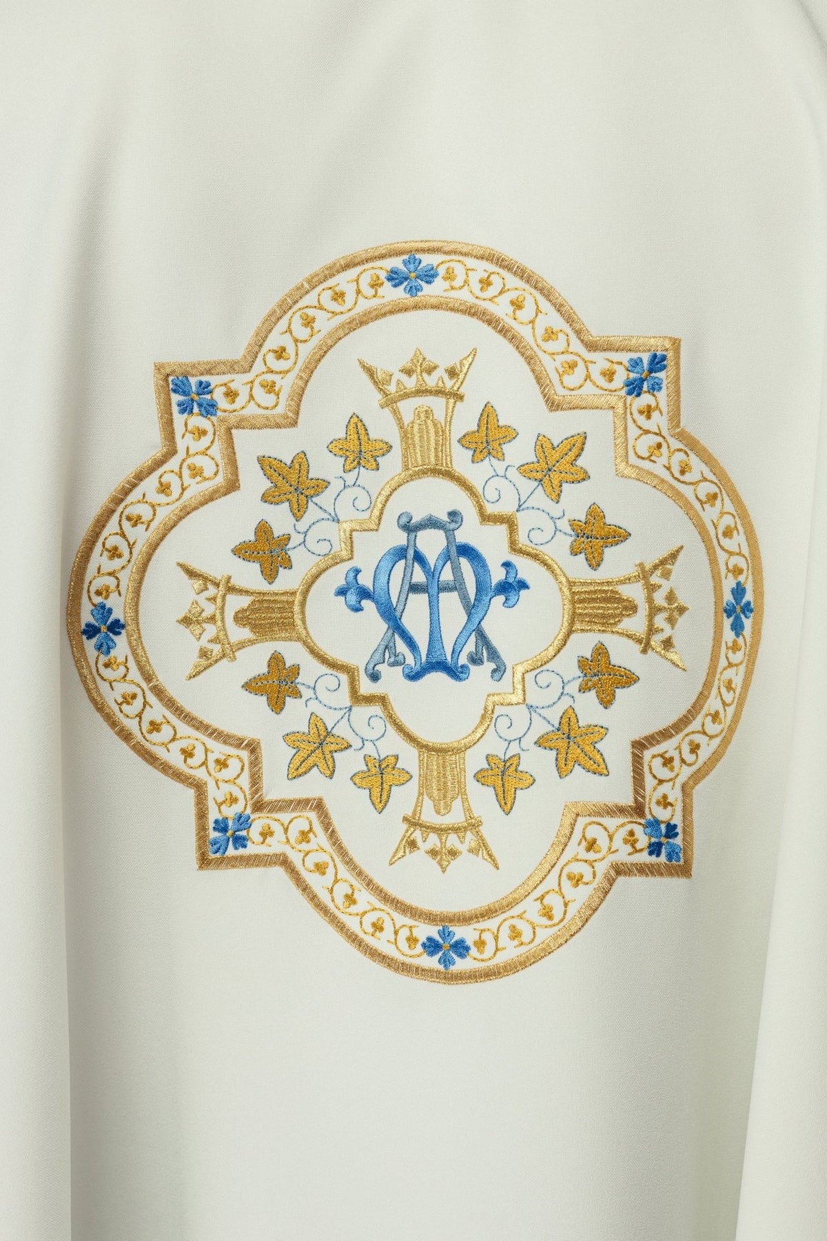 Marian chasuble, close-up of embroidered gold, blue and ecru Marian motif