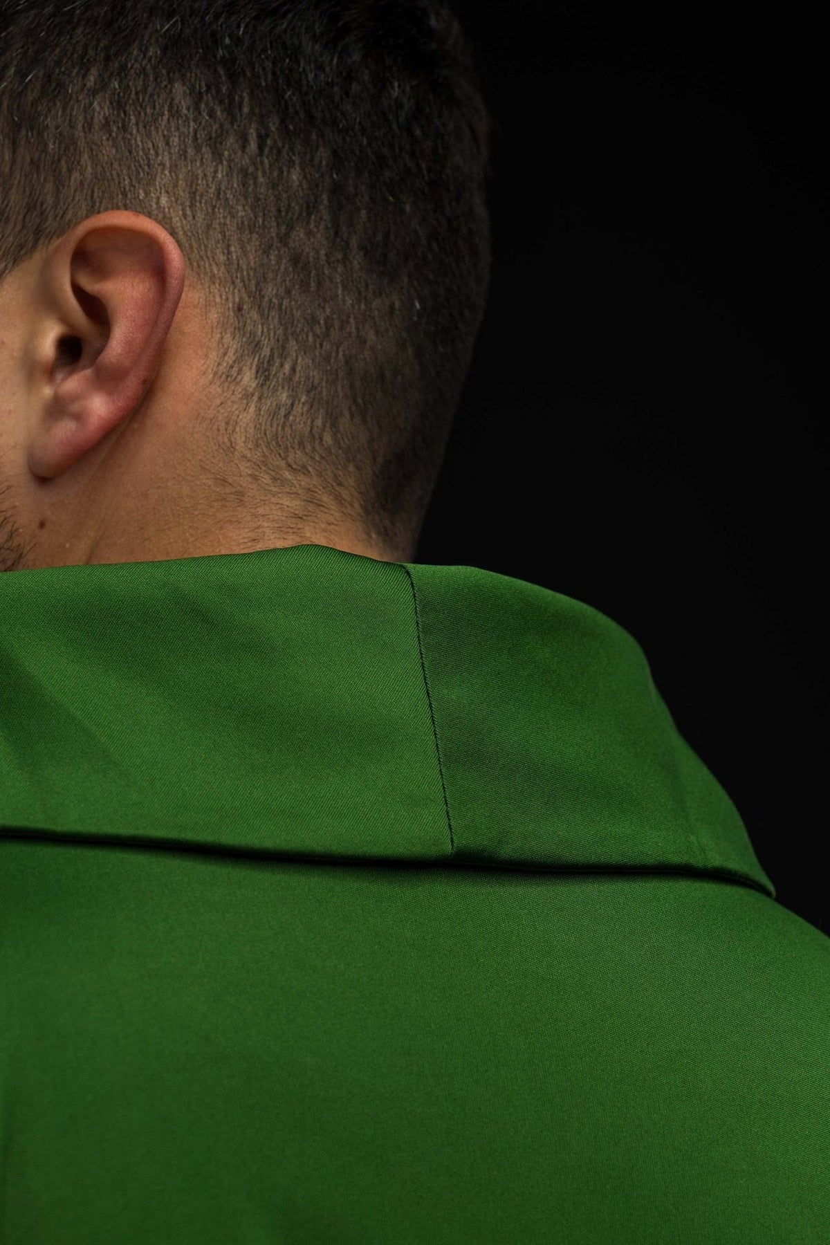 Green chasuble back close-up showing stand-up collar and centre seam