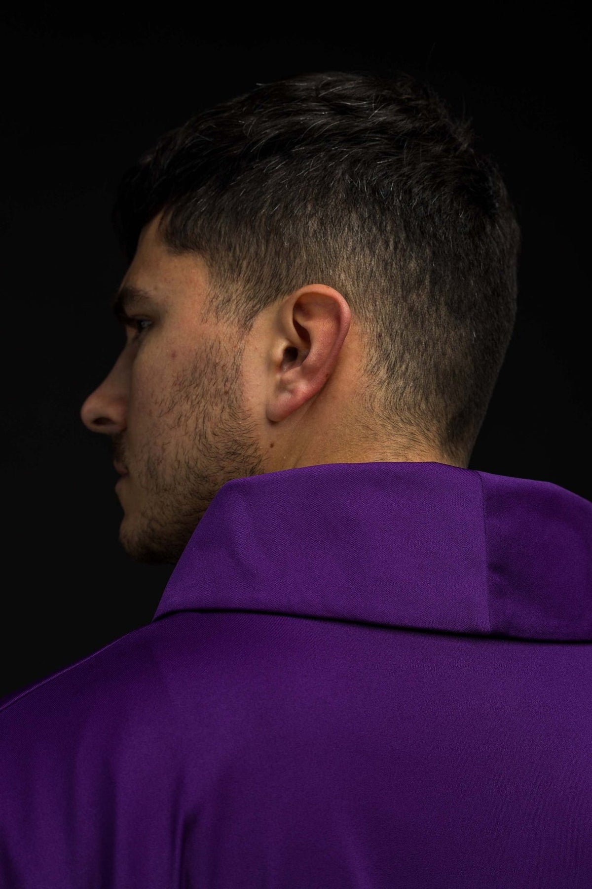 Purple chasuble close-up showing the stand-up collar from the back