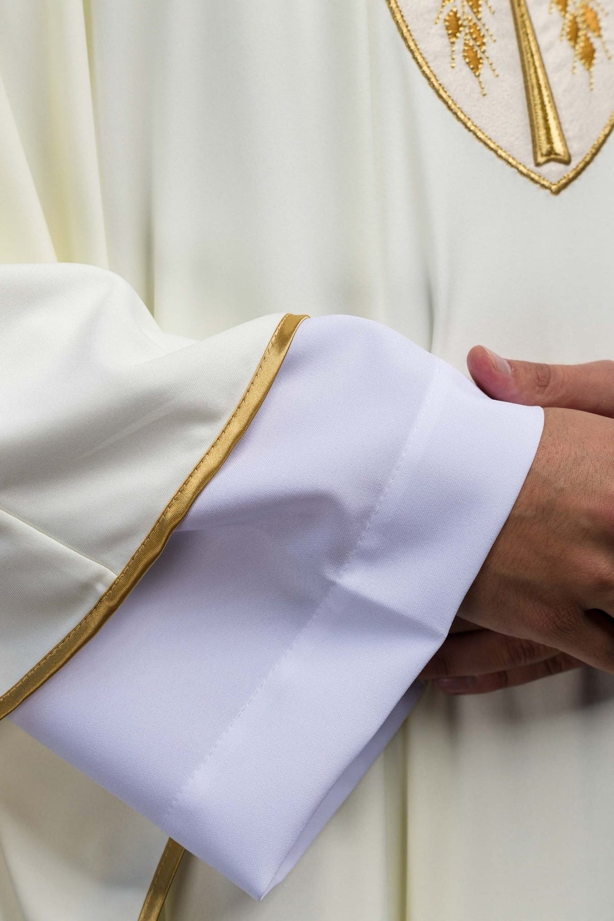 Ecru chasuble sleeve close-up showing white cuff and gold trim