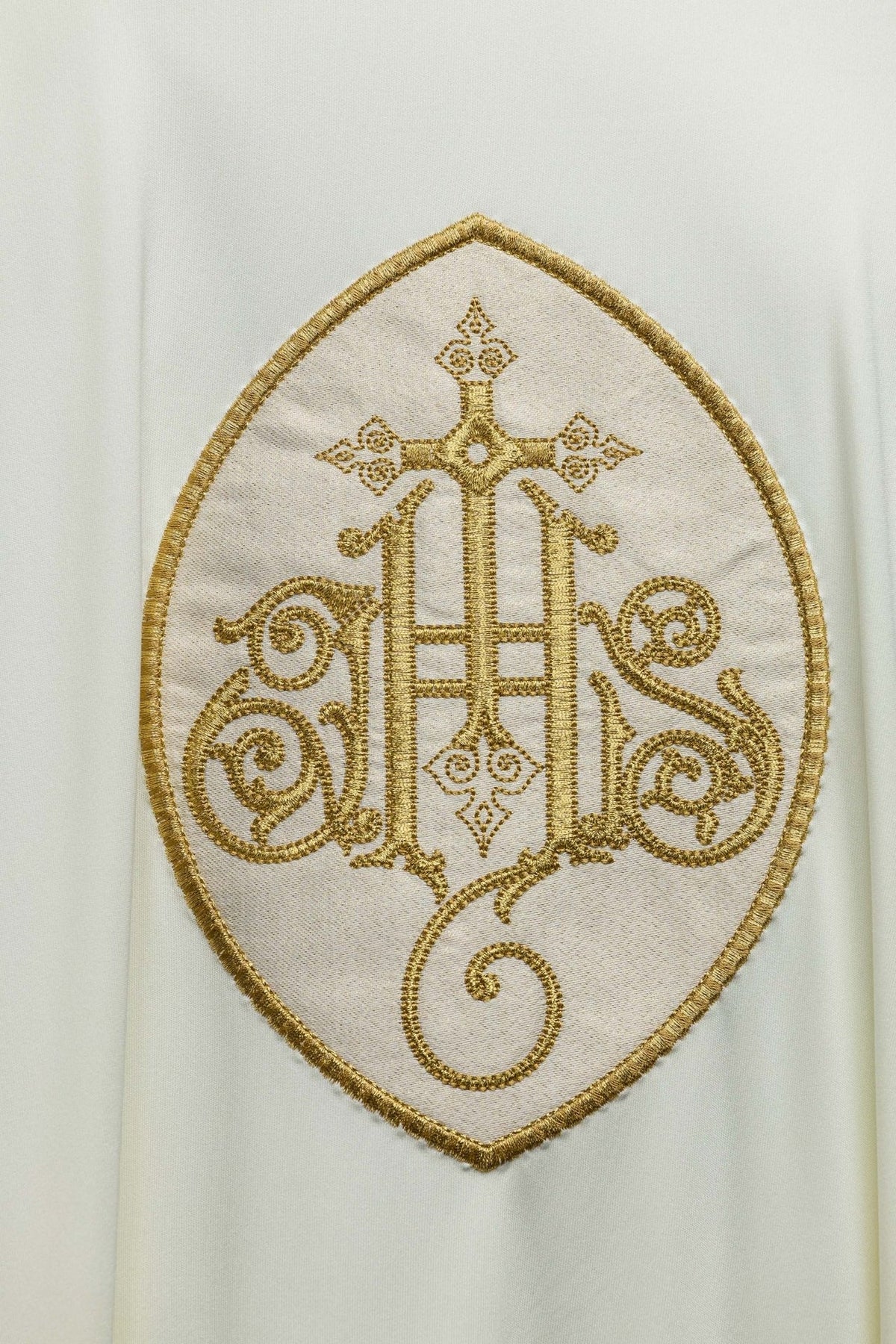SACROLITE knit chasuble IHS embroidery close-up in gold on ecru fabric