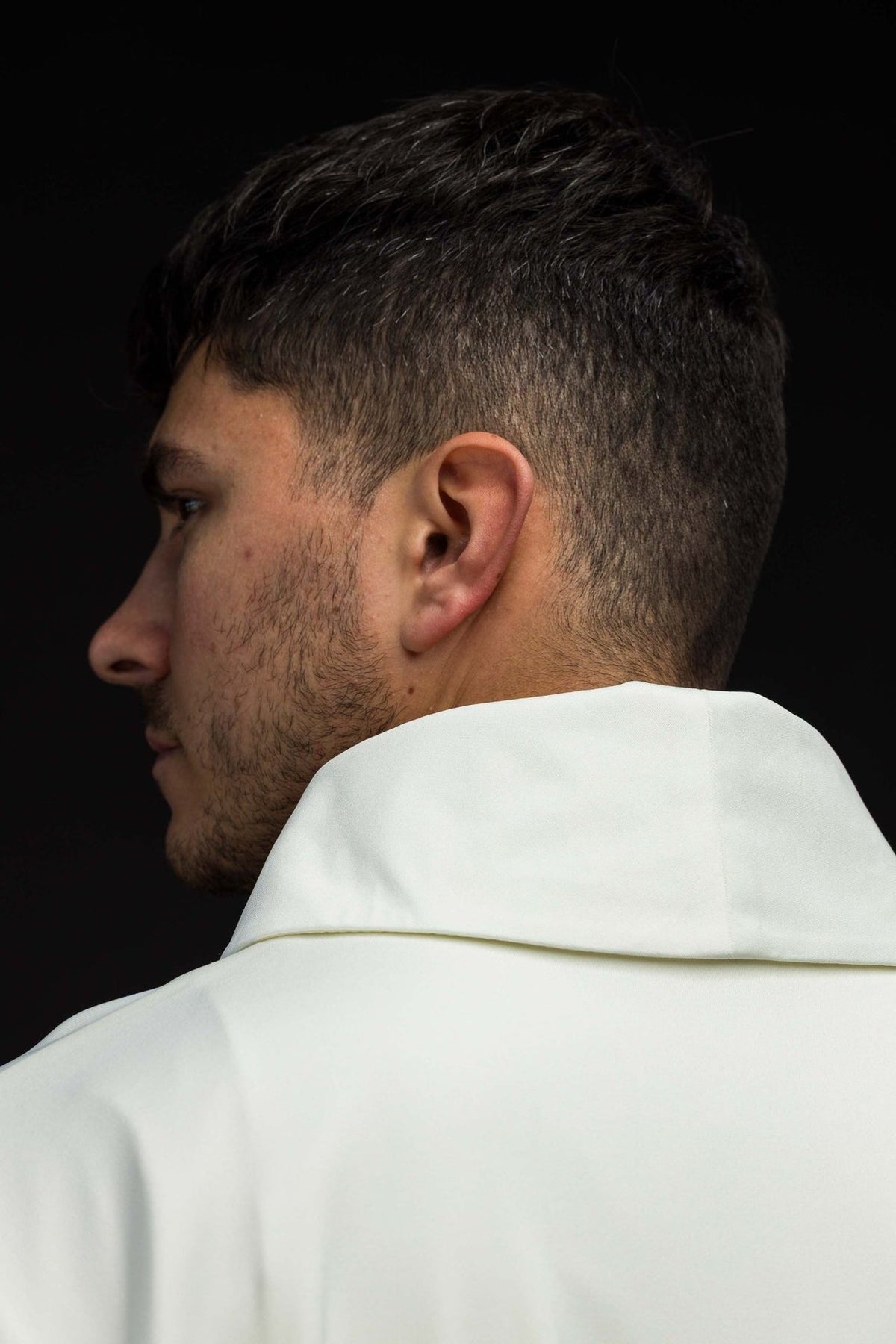SACROLITE knit chasuble, side back close-up showing the stand-up collar