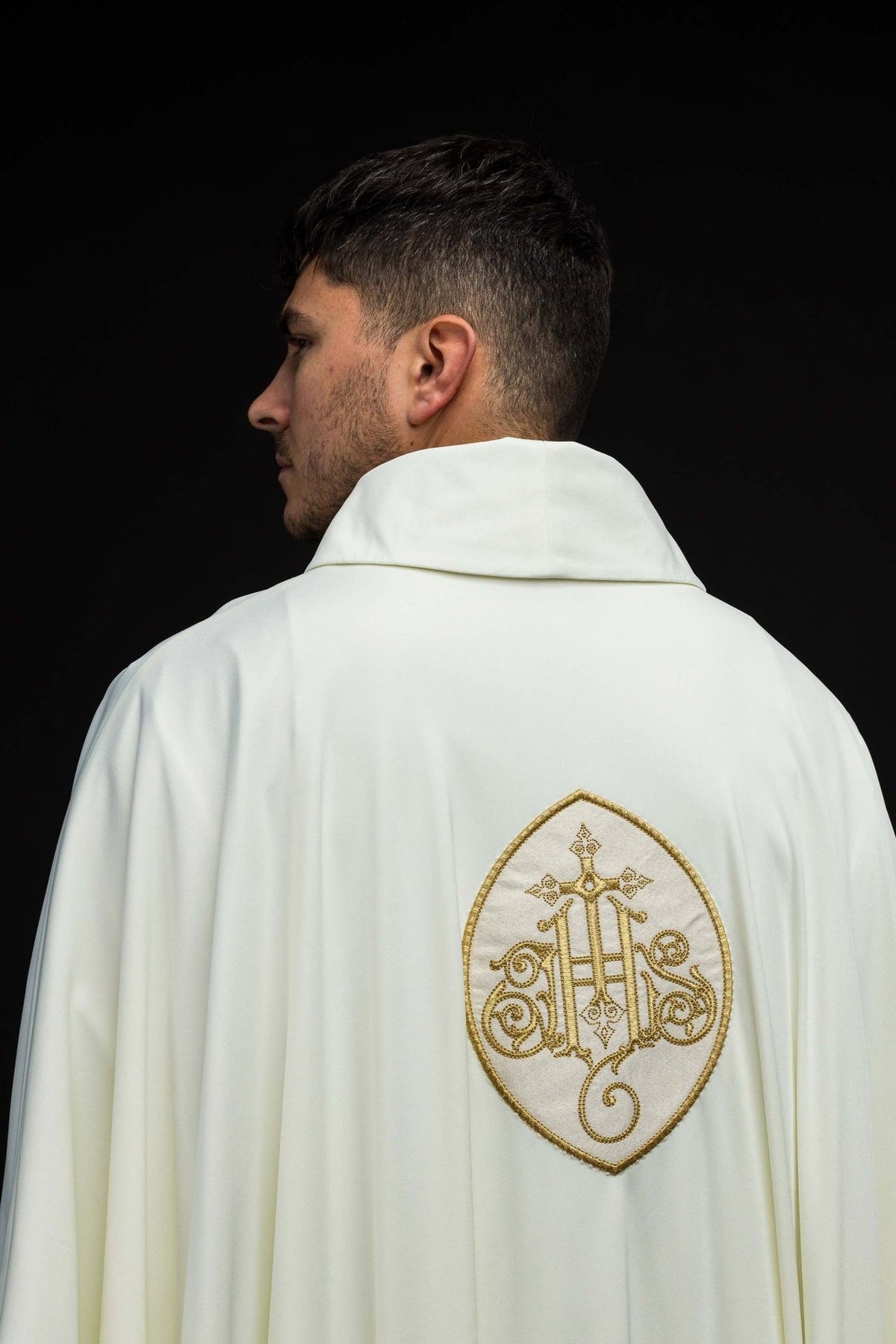 SACROLITE knit chasuble, back view in ecru with gold IHS embroidery