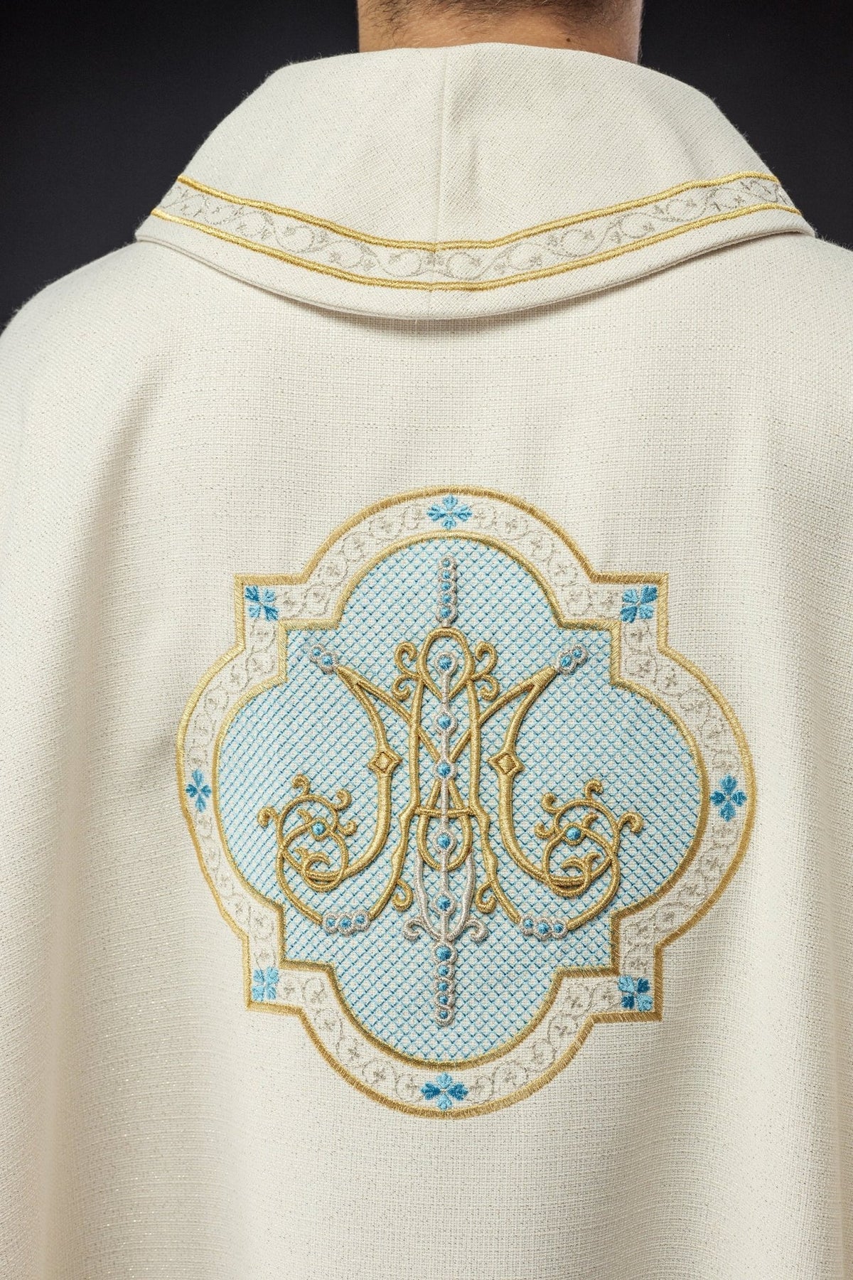 Ecru Marian chasuble, back view with embroidered Marian motif and gold trim