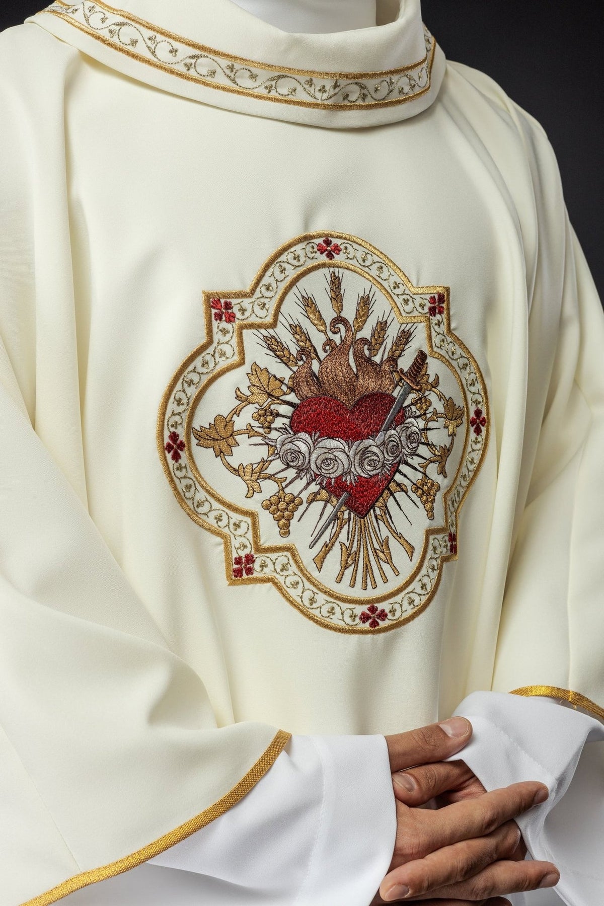 Ecru chasuble front close-up showing Heart of Mary embroidery and gold collar trim