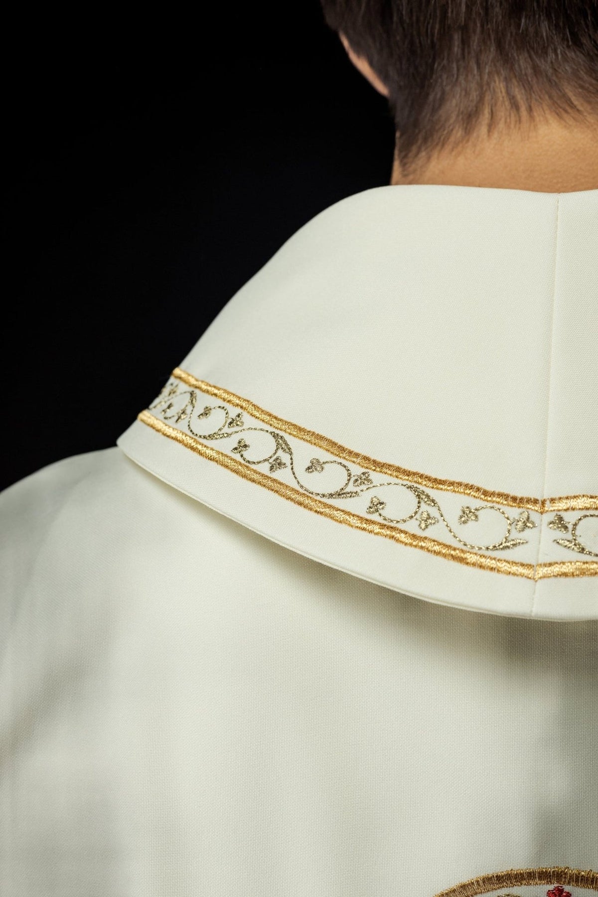 Ecru chasuble collar close-up with gold embroidered trim