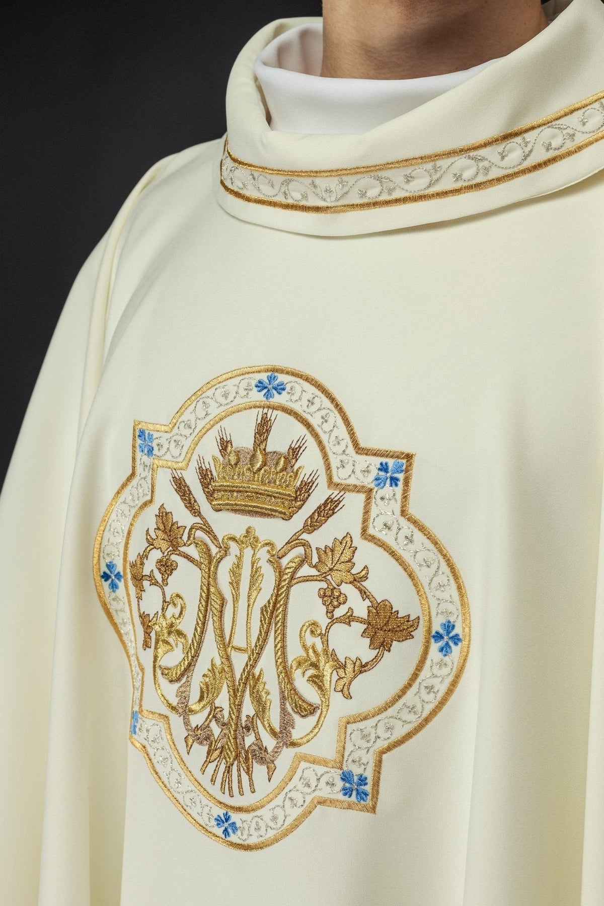 Ecru chasuble front close-up with embroidered Marian motif, blue accents and gold trim