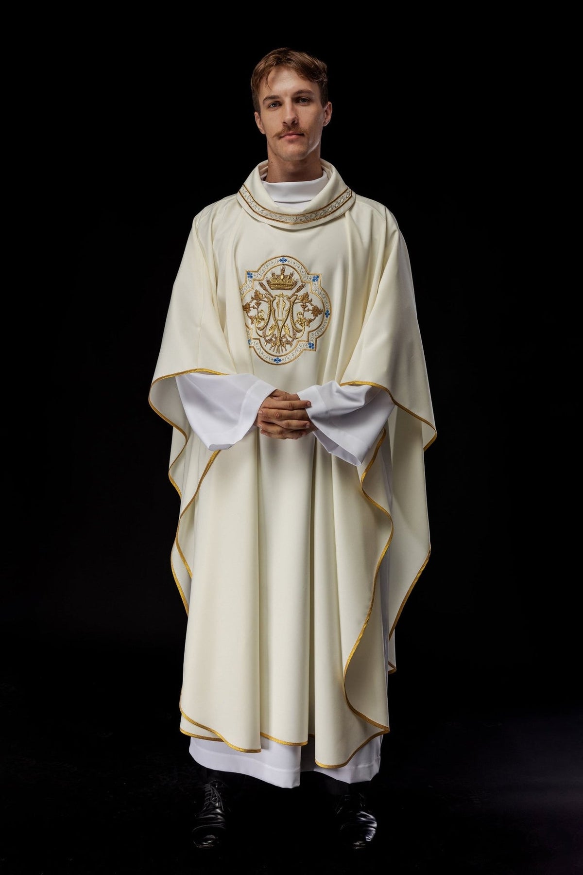 Ecru chasuble worn from the front with embroidered Marian motif and gold trim