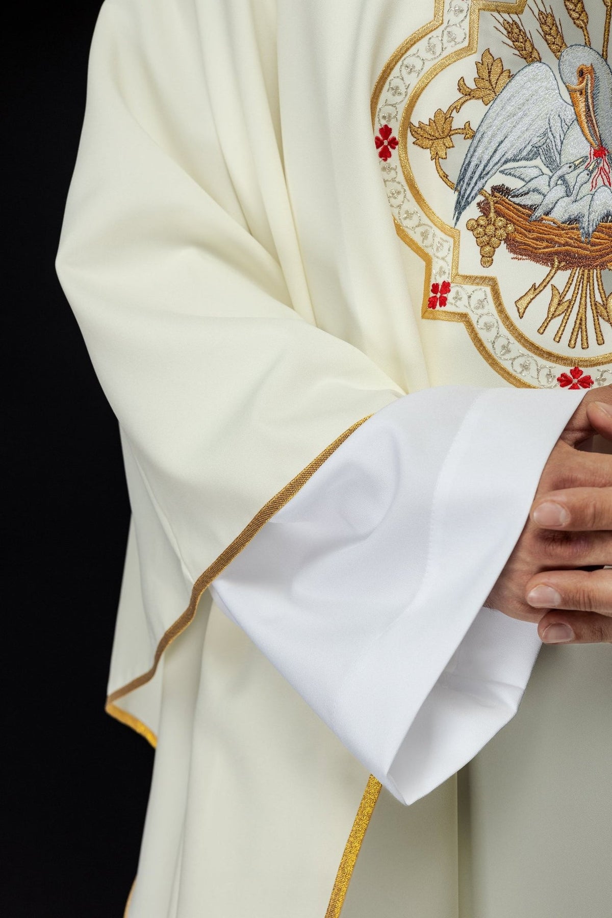 Close-up of the chasuble's embroidered pelican, wheat, grapes and decorative trim