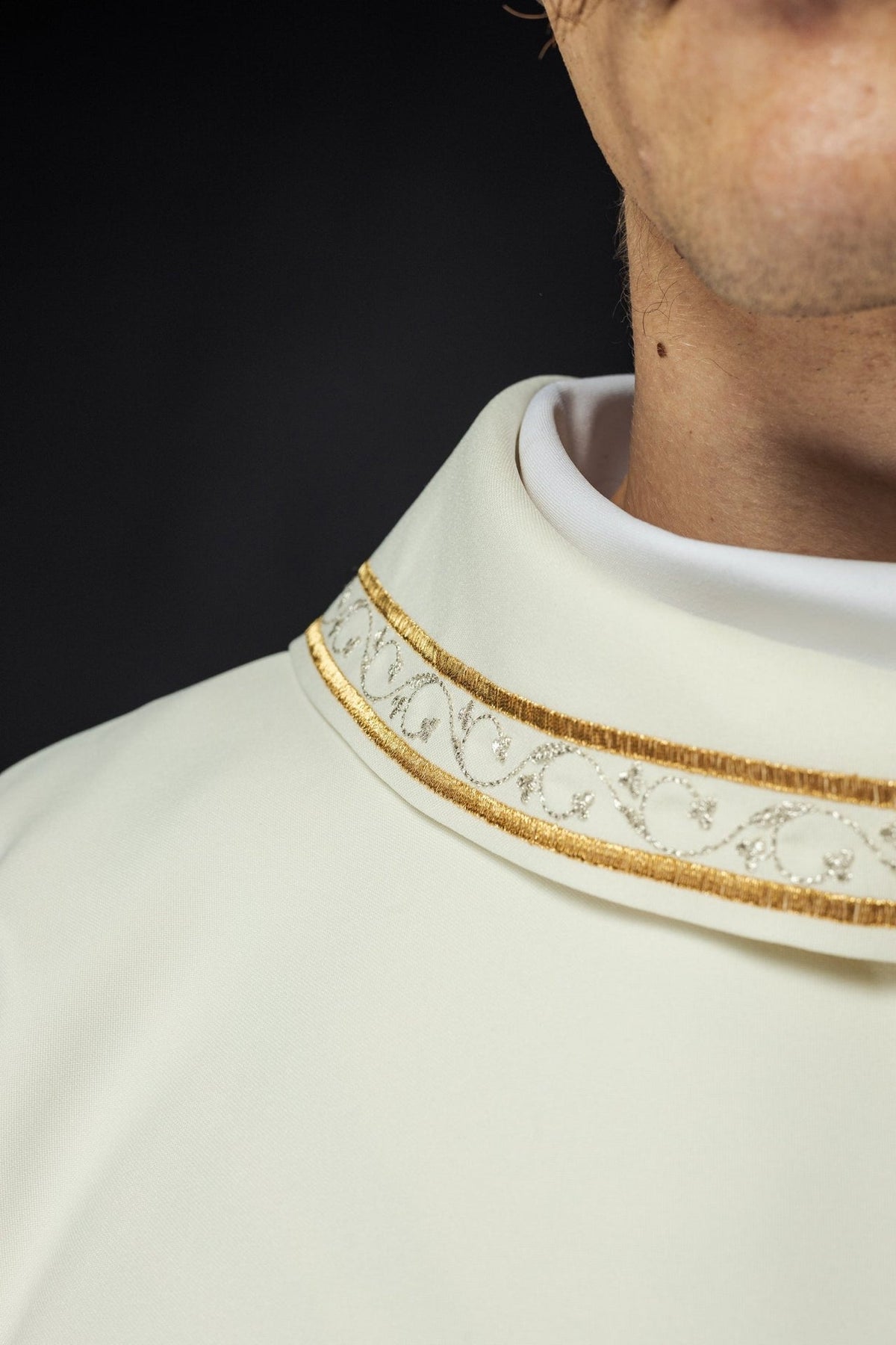 Ecru chasuble sleeve close-up with gold trim and white cuff