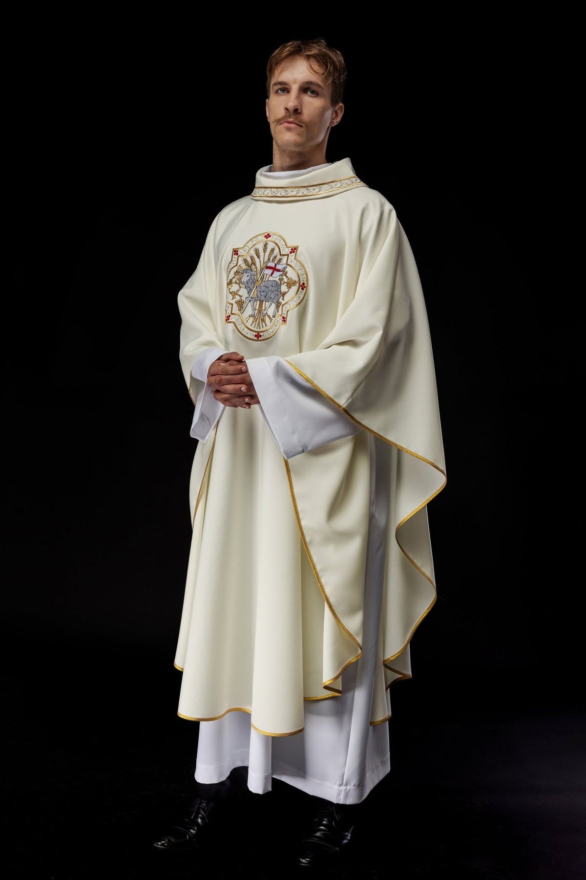 Ecru chasuble worn front view with Agnus Dei embroidery and gold trim