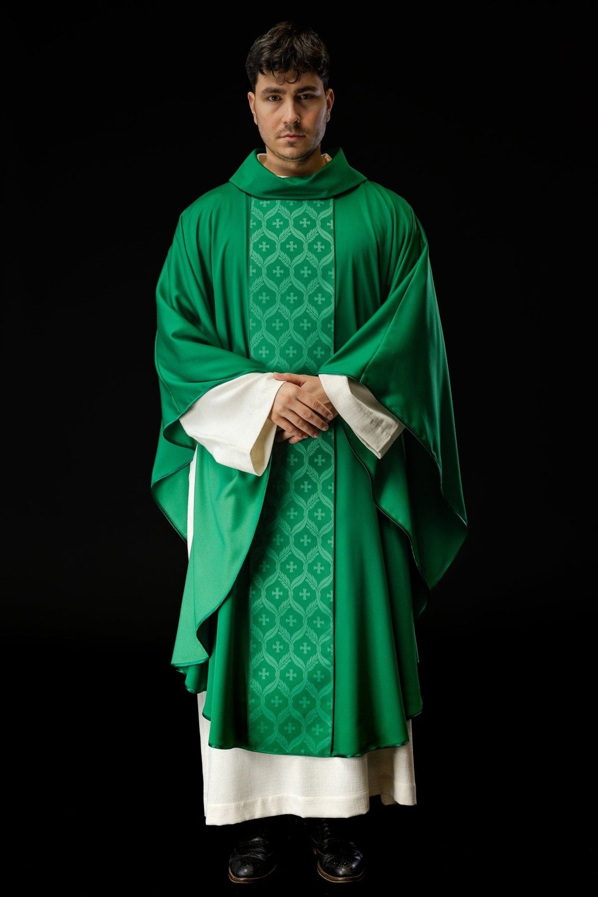 Green chasuble front view showing flowing shape and cross-patterned orphrey