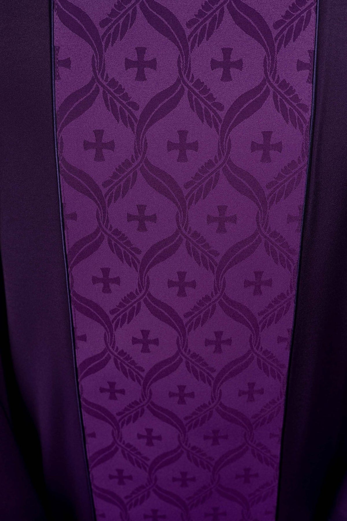 Purple chasuble jacquard orphrey close-up with repeating crosses