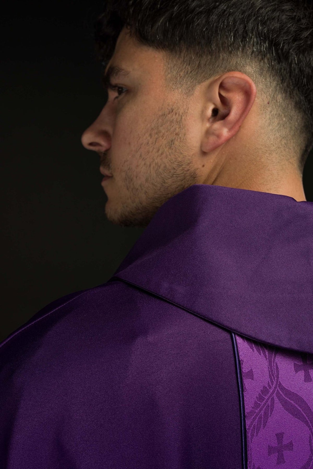 Purple chasuble side view showing satin collar and trim