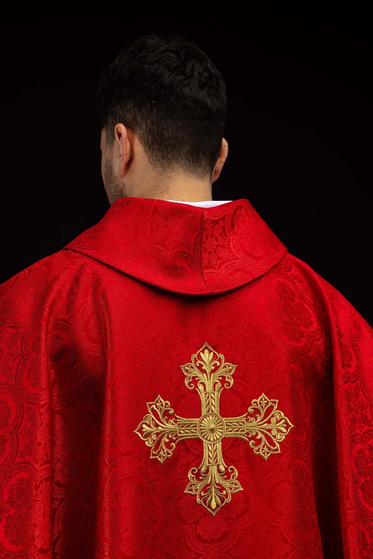 Red chasuble shoulder detail showing jacquard fabric and stand-up collar