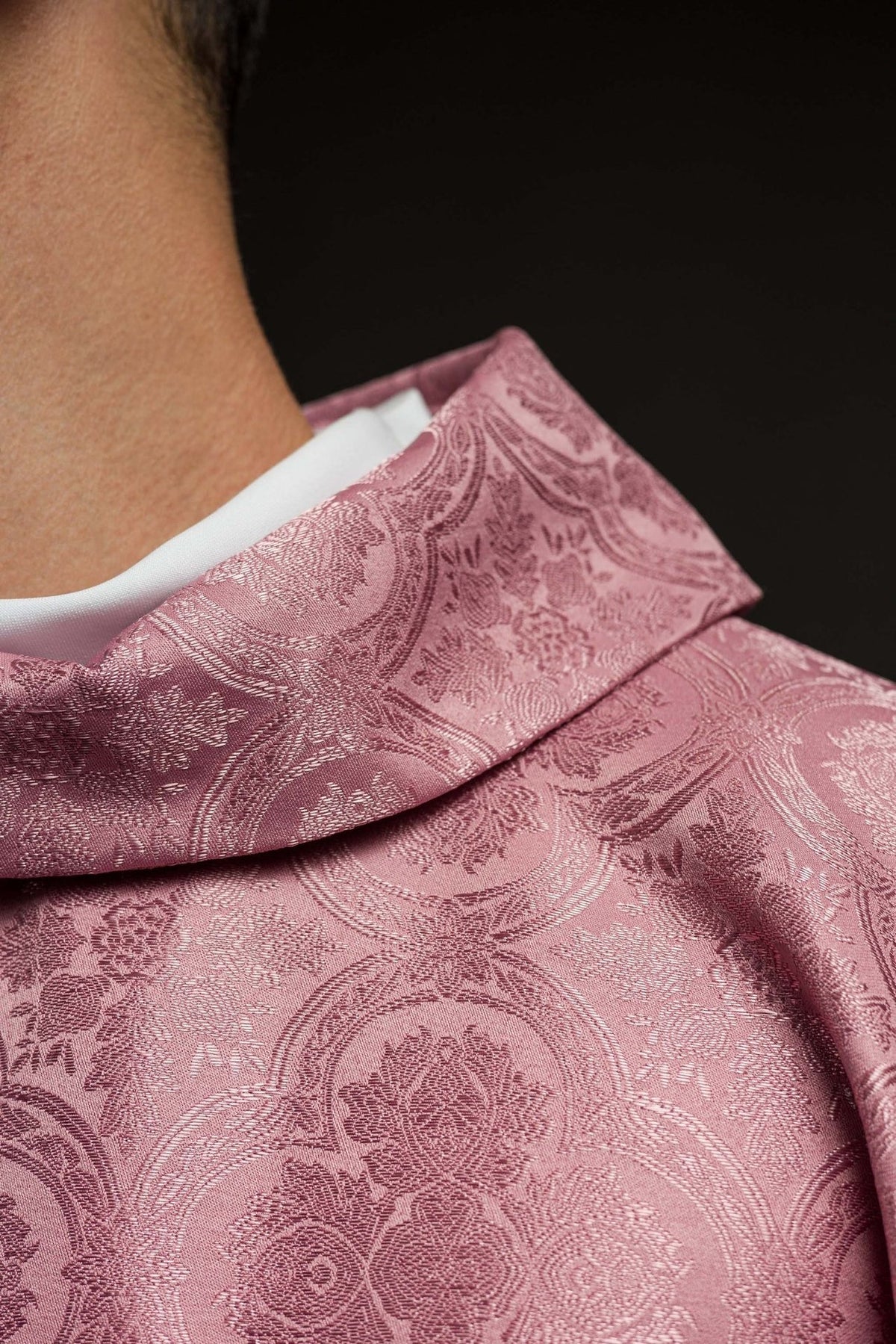 Rose chasuble close-up showing patterned fabric and stand-up collar