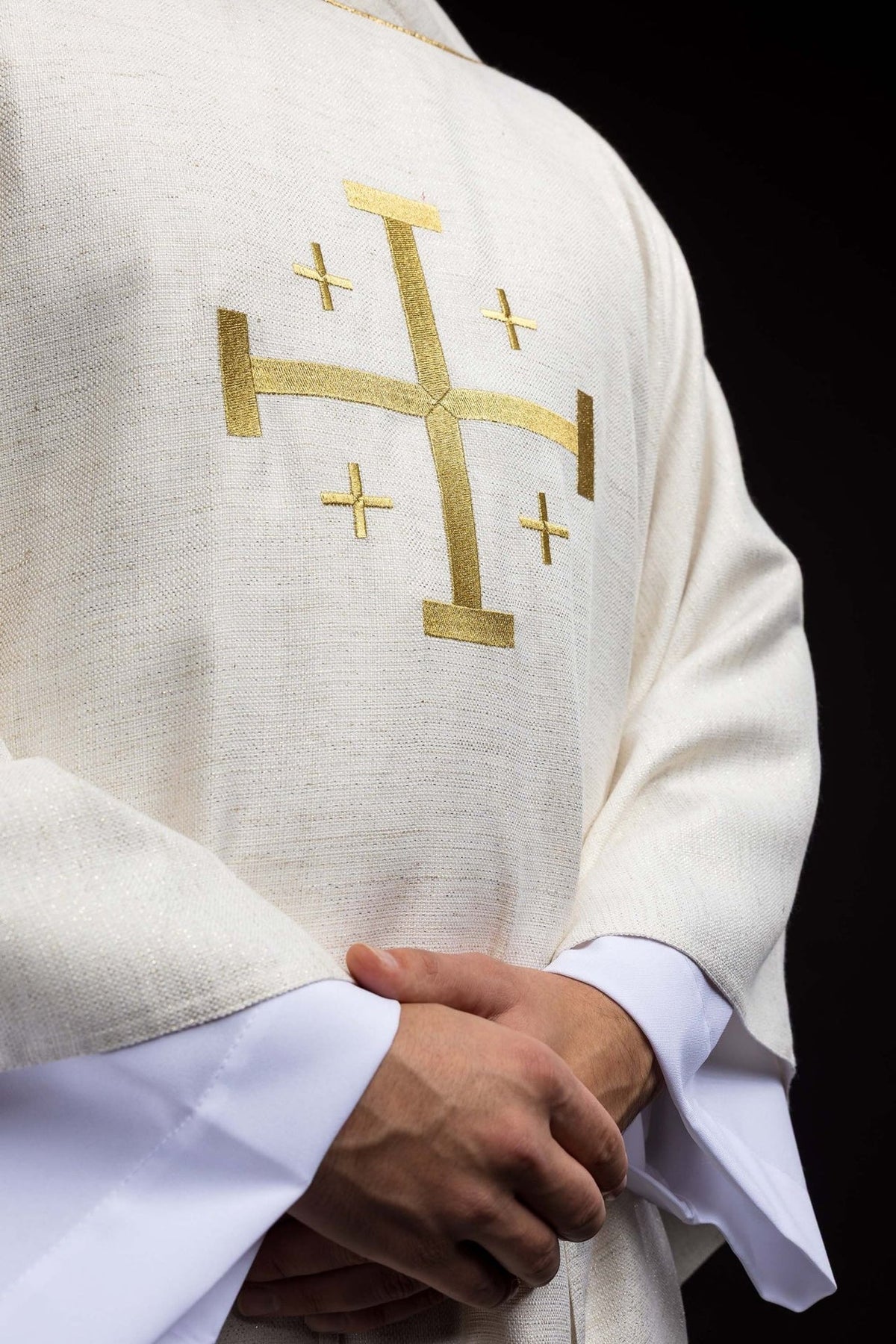 Chasuble detail showing gold Jerusalem cross embroidery and ecru fabric