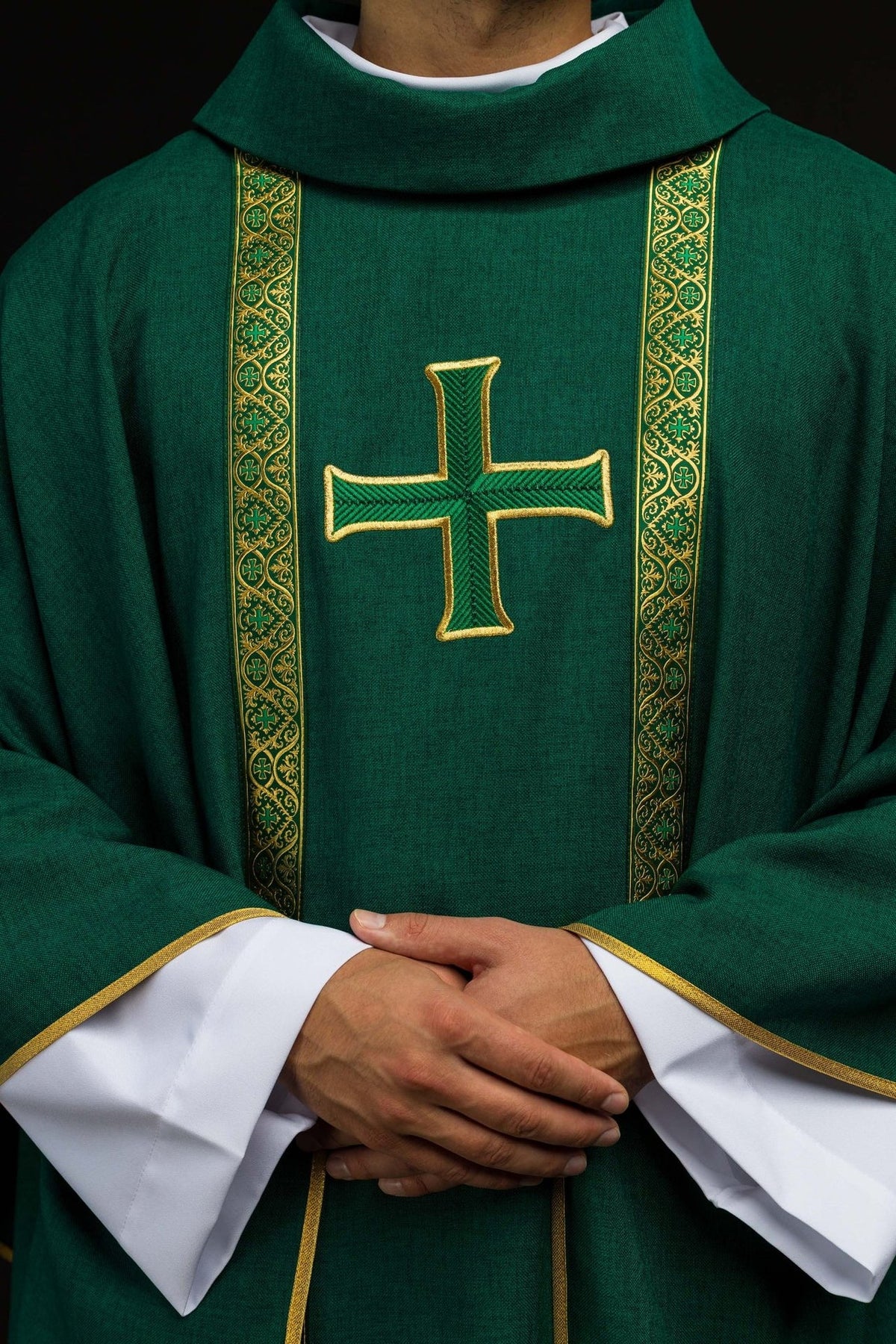 Green chasuble front close-up with embroidered cross and patterned orphreys
