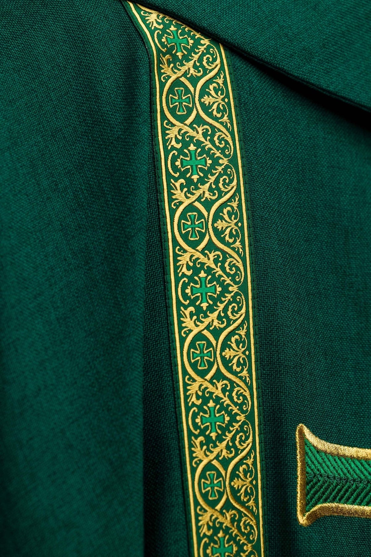 Green chasuble jacquard orphrey close-up with gold cross motifs