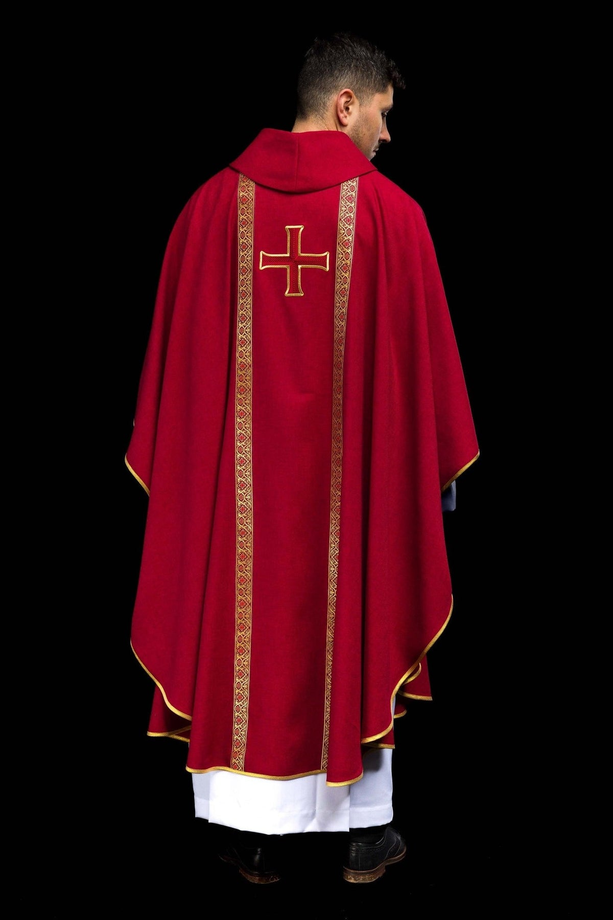 Red chasuble close-up of embroidered cross and gold patterned orphrey