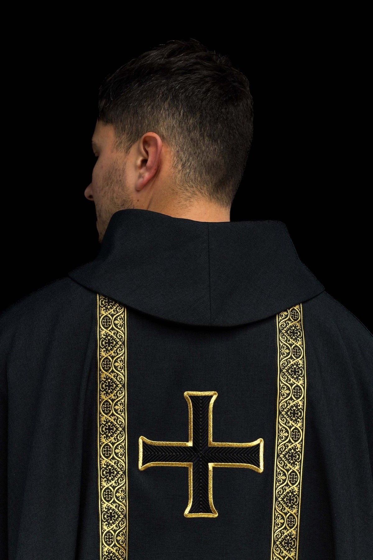 Black chasuble back view with gold embroidered cross and jacquard orphreys