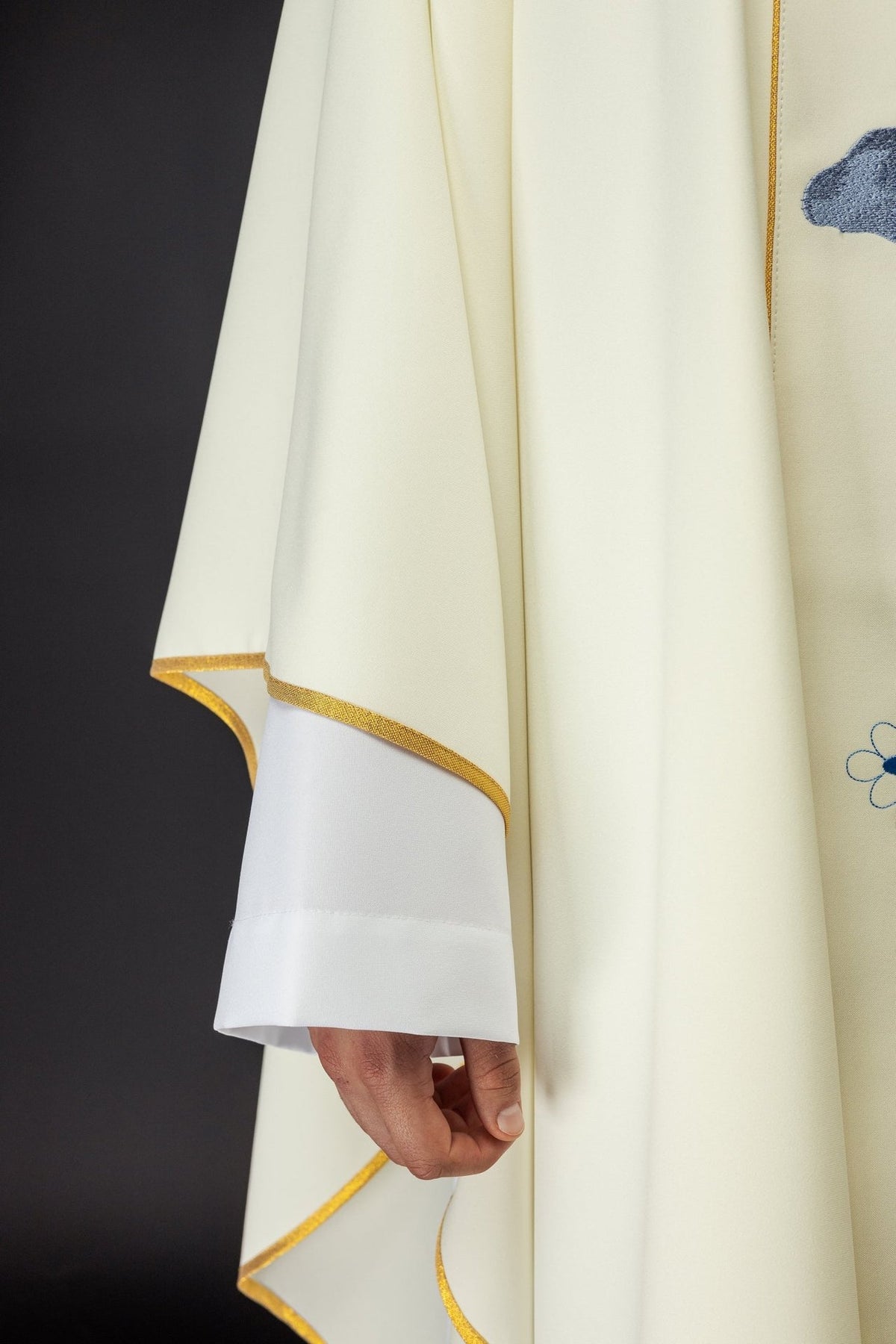 Chasuble sleeve close-up with gold trim and white cuff