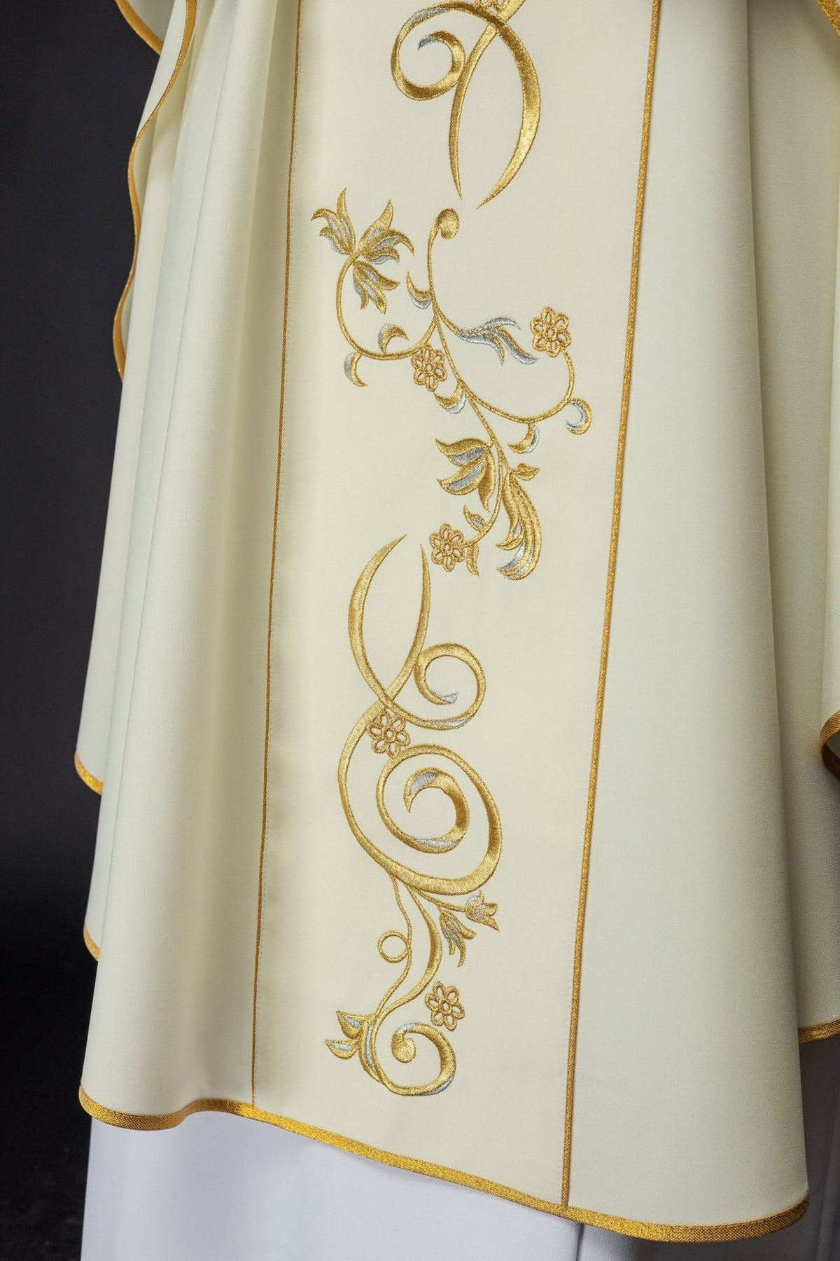 Chasuble close-up of gold and silver floral scroll embroidery on the front