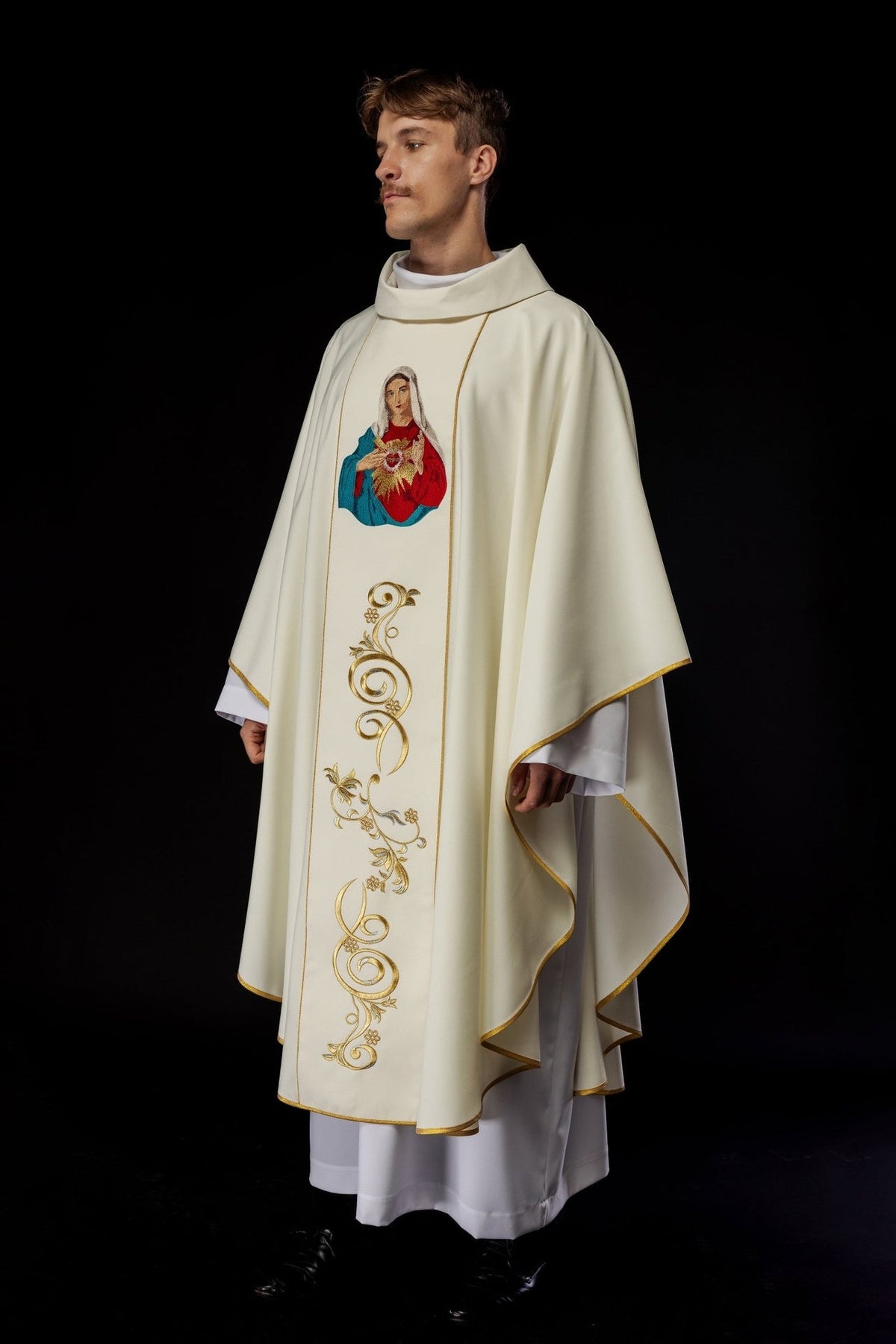 Heart of Mary chasuble, side worn view with flowing sleeves and gold trim