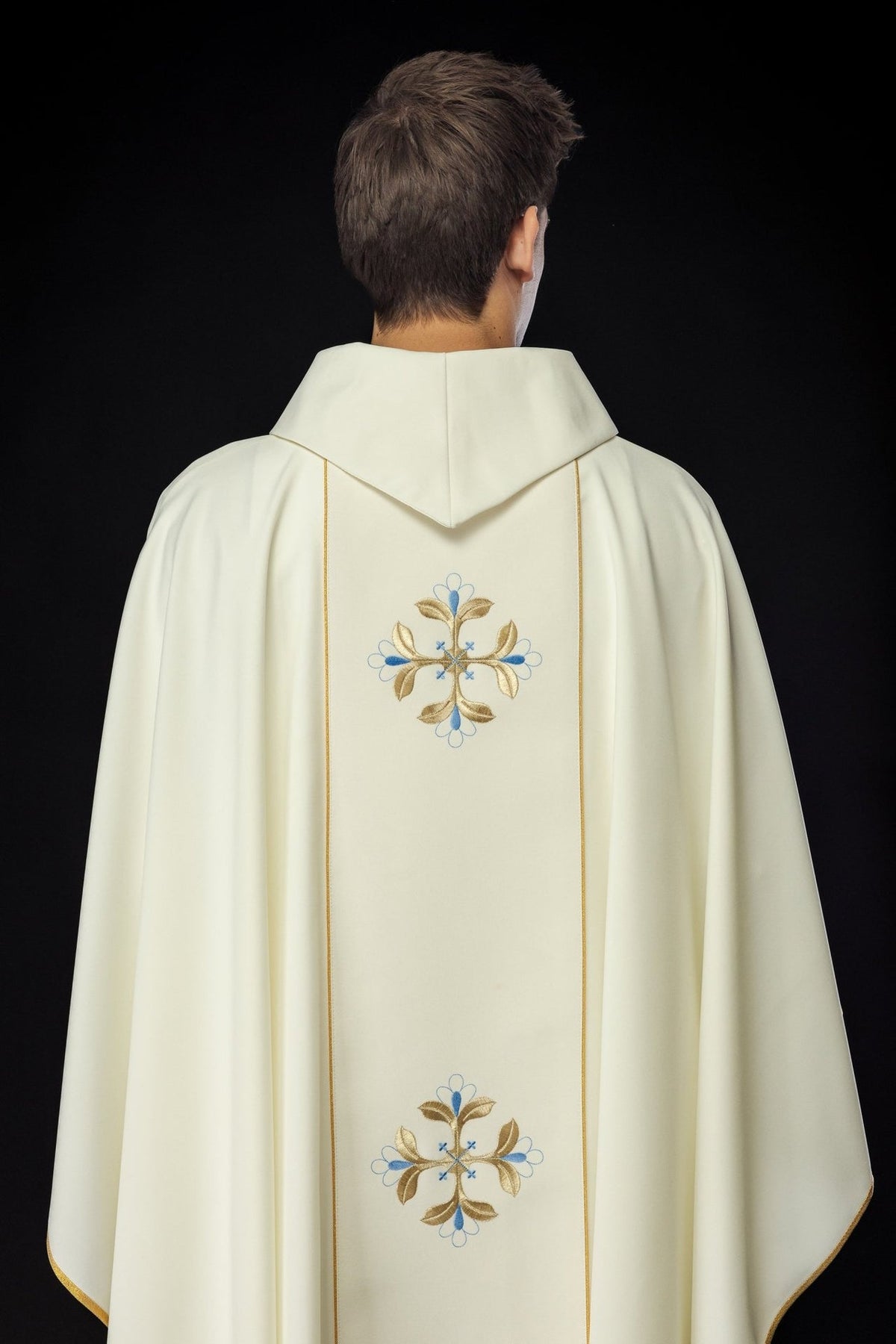 Chasuble back close-up showing ivory stand-up collar and embroidered floral motif
