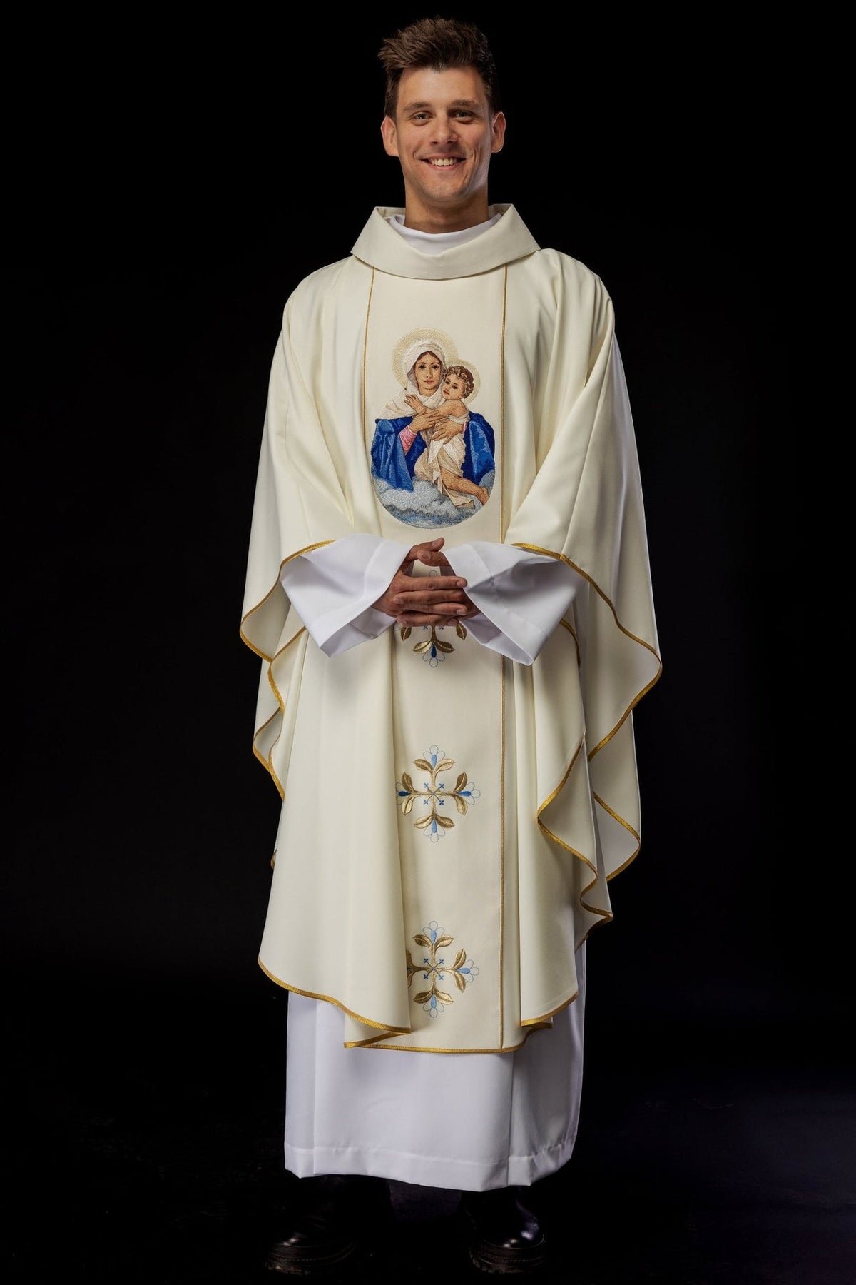 Chasuble front view showing embroidered Our Lady and Child image and gold-edged sleeves
