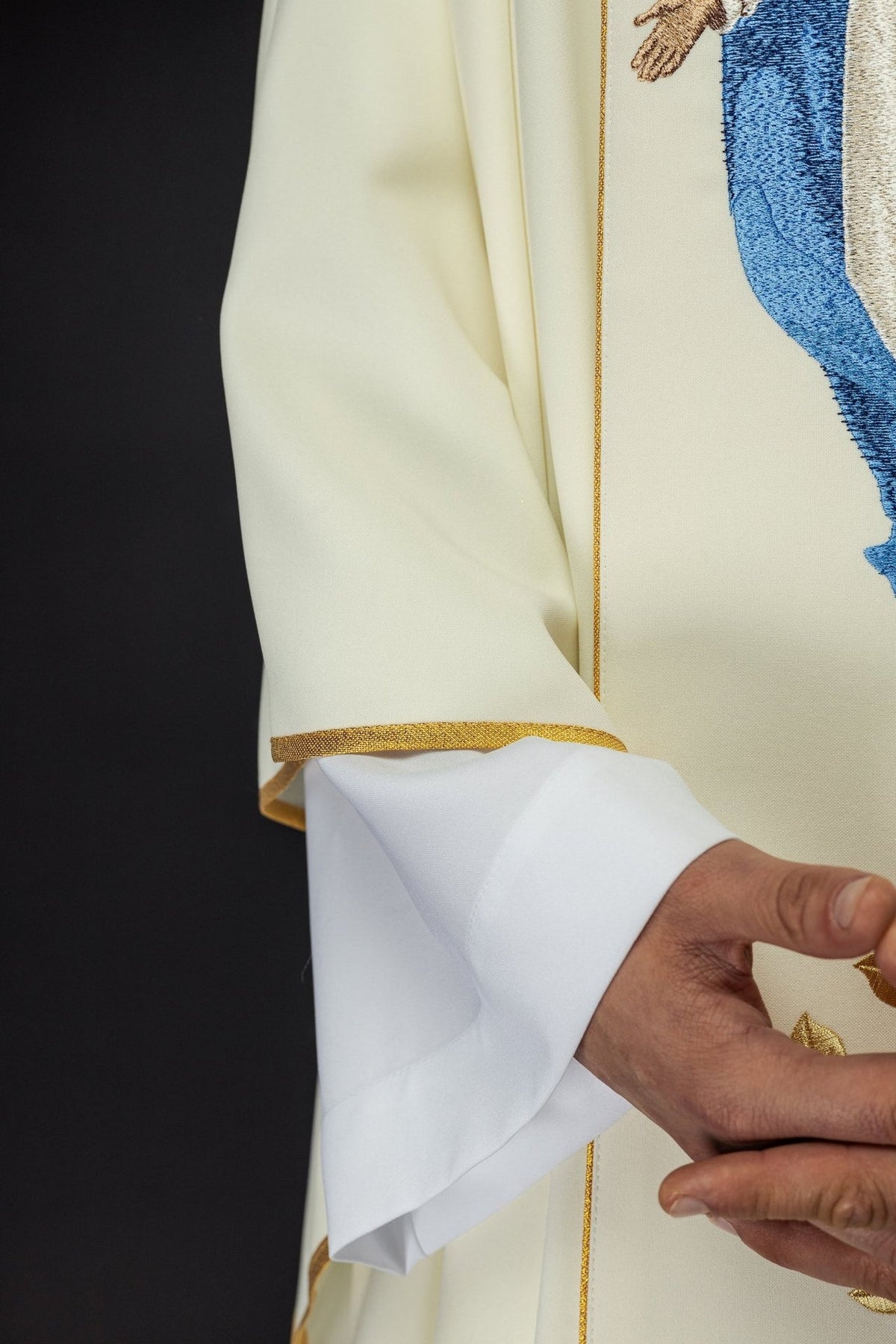 Chasuble sleeve close-up with gold trim and white cuff