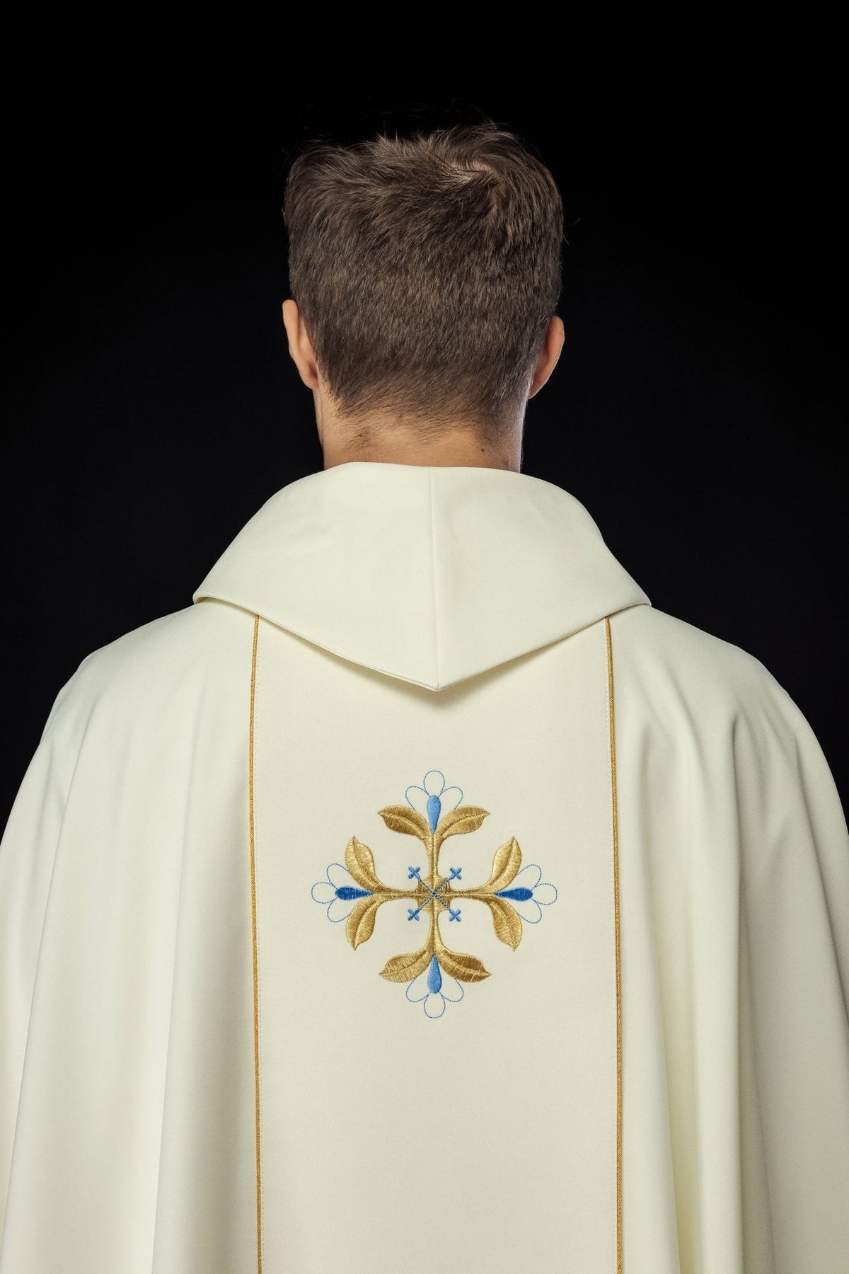 Chasuble back view with blue and gold embroidered floral motifs