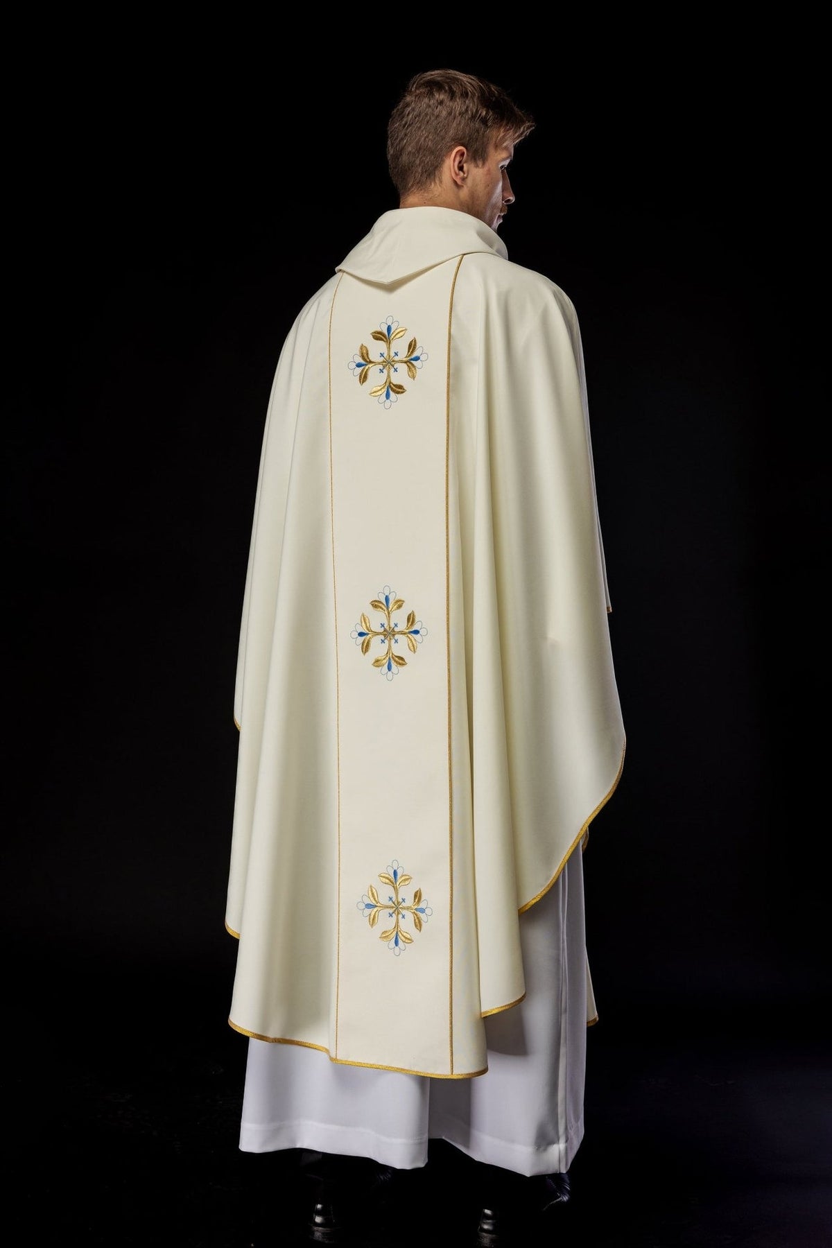 Chasuble three-quarter back view with embroidered floral motifs and gold trim