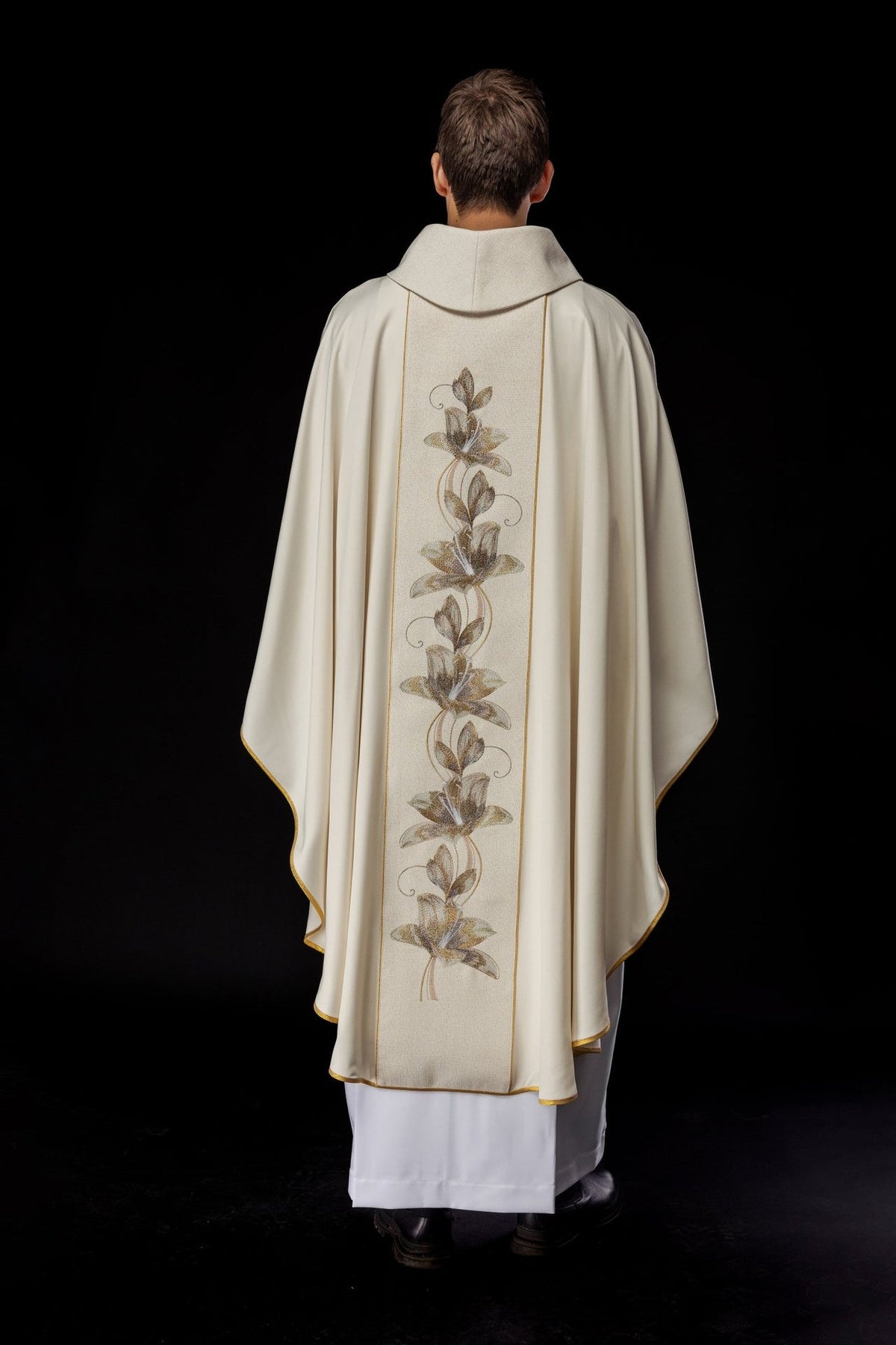 Gold chasuble back view with floral embroidered orphrey