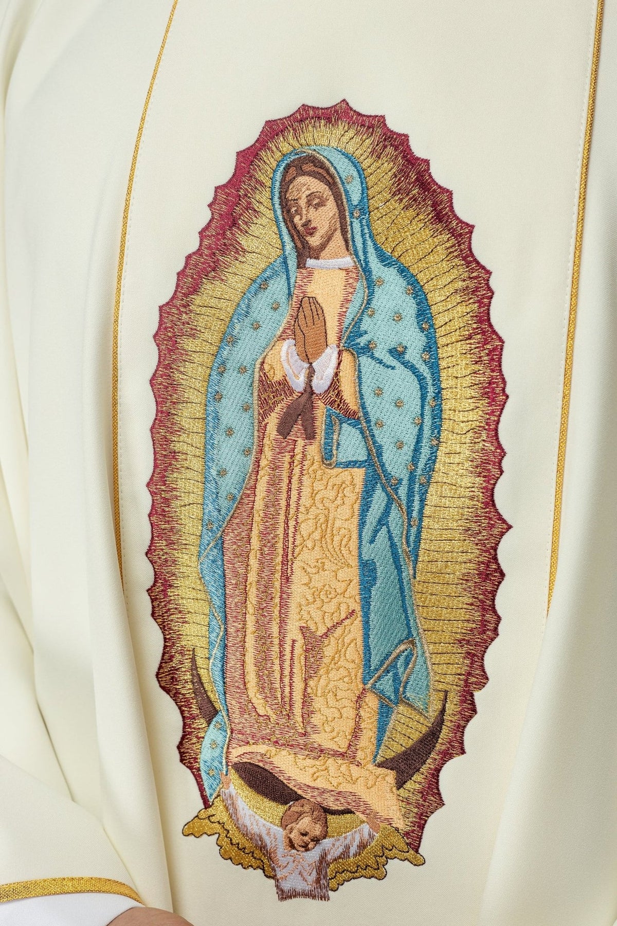 Our Lady embroidery close-up on the ivory chasuble
