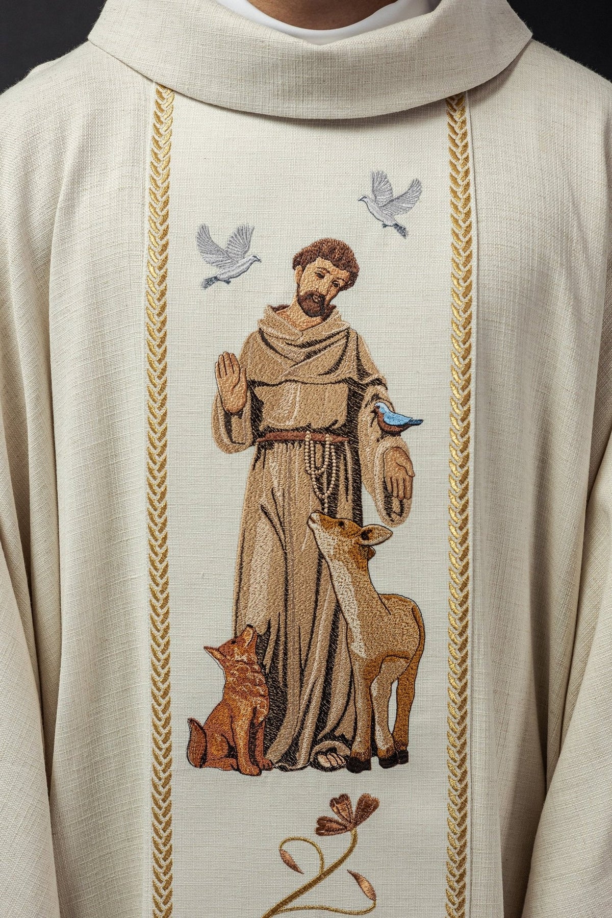 Chasuble close-up showing embroidered Saint Francis with birds, deer and fox