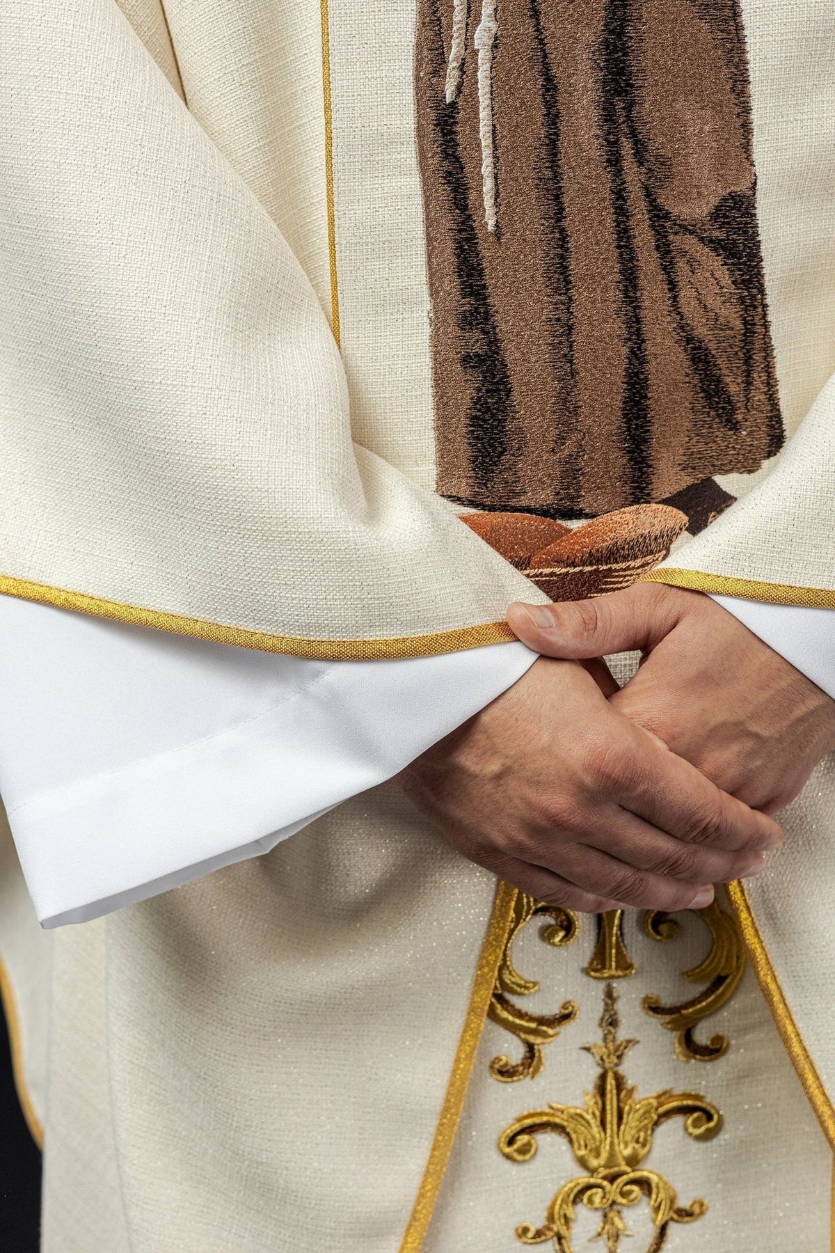 Saint Anthony chasuble detail of white fabric and gold trim at the sleeve