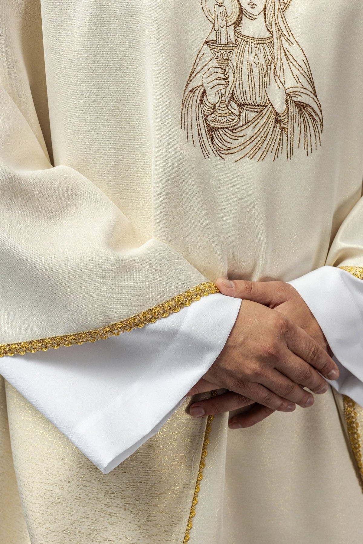 Candlemas chasuble close-up showing ivory satin and gold trim at the sleeve