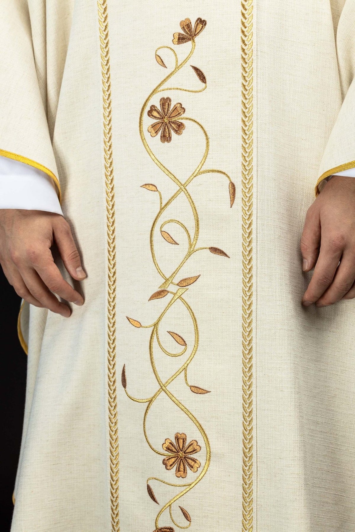 Ecru chasuble close-up showing embroidered floral orphrey with gold trim