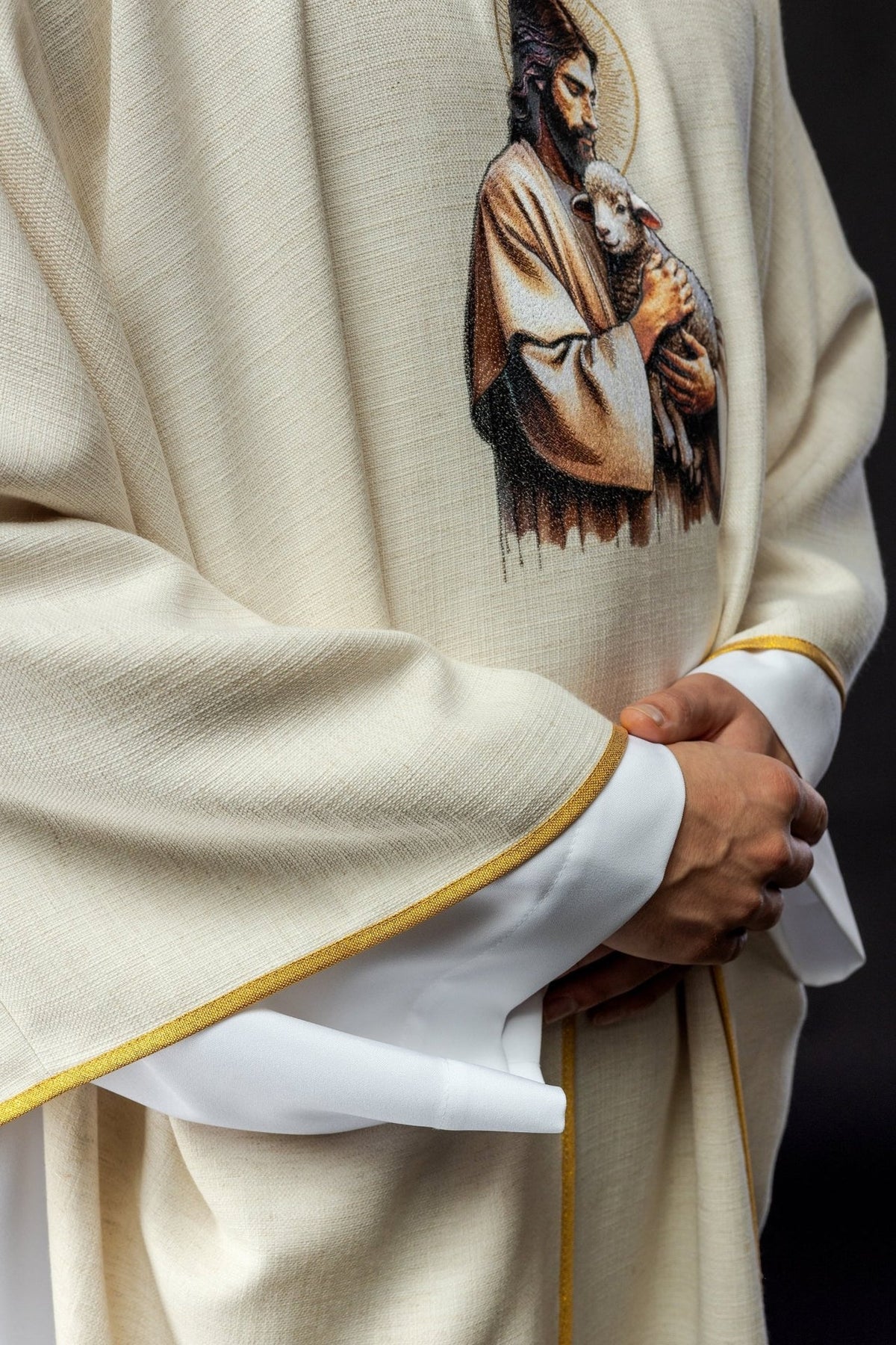 Ecru chasuble side close-up with Good Shepherd embroidery and gold trim