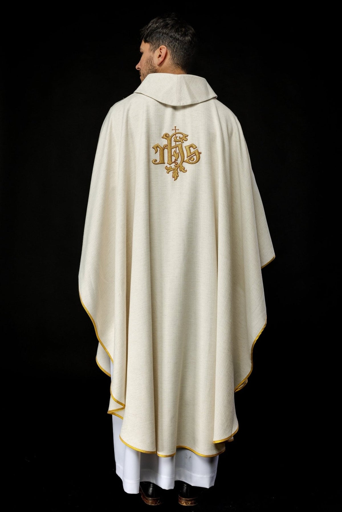 Ecru chasuble back view with gold IHS embroidery and trim